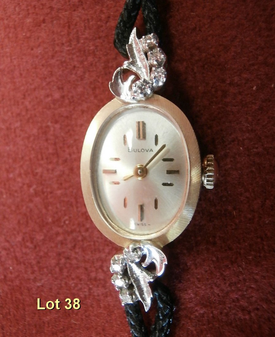 14Kt Gold Ladies Watch With Diamonds: 14Kt Gold Ladies Watch With 8 Diamonds. On the back of the watch Marked N0 Date codes to 1970 Ser#40206. Has a Cloth Champion Band Total Length 6 1/2"