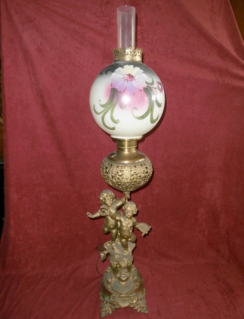Triumph of Arts Double Cherub Banquet Lamp: Triumph of Arts double cherub banquet lamp with floral ball shade. 40" tall, 9" ball shade. Numbers engraved on item.