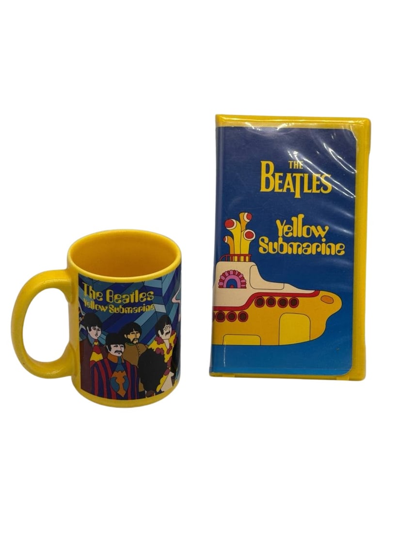 The Beatles Yellow Submarine VHS Tape And Mug Set Collectible Original: The Beatles Yellow Submarine VHS Tape and Mug Set is a must-have for fans of the legendary band and collectors of vintage memorabilia. This set includes a vibrant yellow VHS tape featuring the iconic 