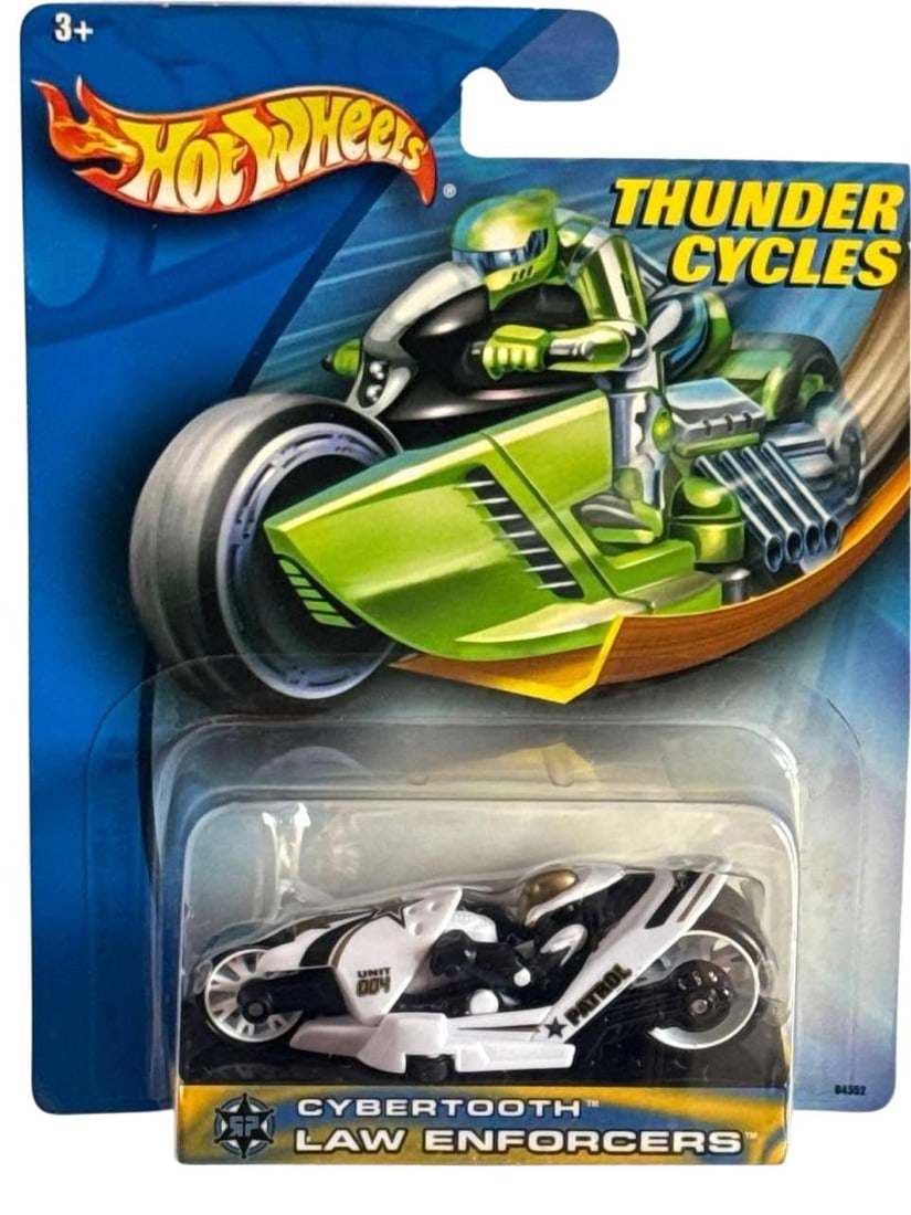 Hot Wheels Thunder Cycles Cybertooth Law Enforcers White 2In: Hot Wheels Thunder Cycles Cybertooth Law Enforcers is a remarkable collectible die-cast motorcycle from Mattel. This limited edition piece features futuristic styling bold white and black accents and