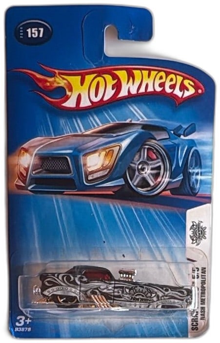 Hot Wheels Scrapheads Nash Metropolitan 157 Black Silver 2004 Diecast Car: Hot Wheels Scrapheads Nash Metropolitan #157 diecast car, released in 2004. Features intricate black and silver custom graphics, chrome engine, red windows, and metallic accents. Still sealed on origi