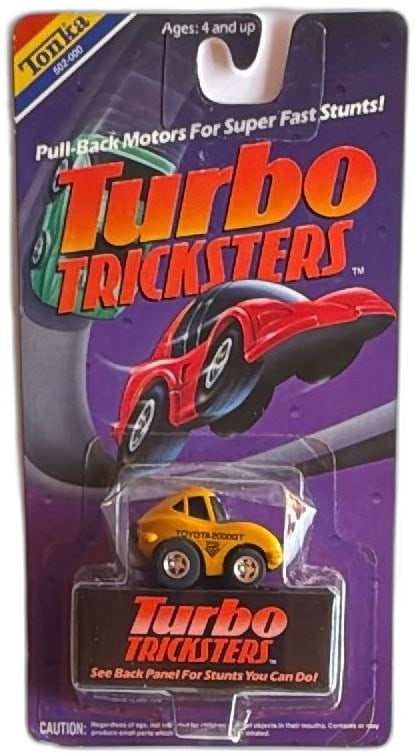 Tonka Turbo Tricksters Toyota 2000GT Yellow Diecast Car New 1989 Sealed: Tonka Turbo Tricksters Toyota 2000GT diecast pull-back stunt car, yellow, 1989, new on original card. Features pull-back motor for wheelies and stunts, rare “Toyota 2000GT” variant. Card displ