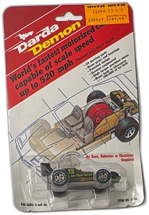 Darda Demon John Player Special 12 Motorized Pull Back Car 1986 Sealed: Vintage Darda Demon John Player Special #12 motorized pull-back car, made in West Germany, 1986, and sealed in original packaging. Collectible black and gold Formula 1 die-cast style toy features bran