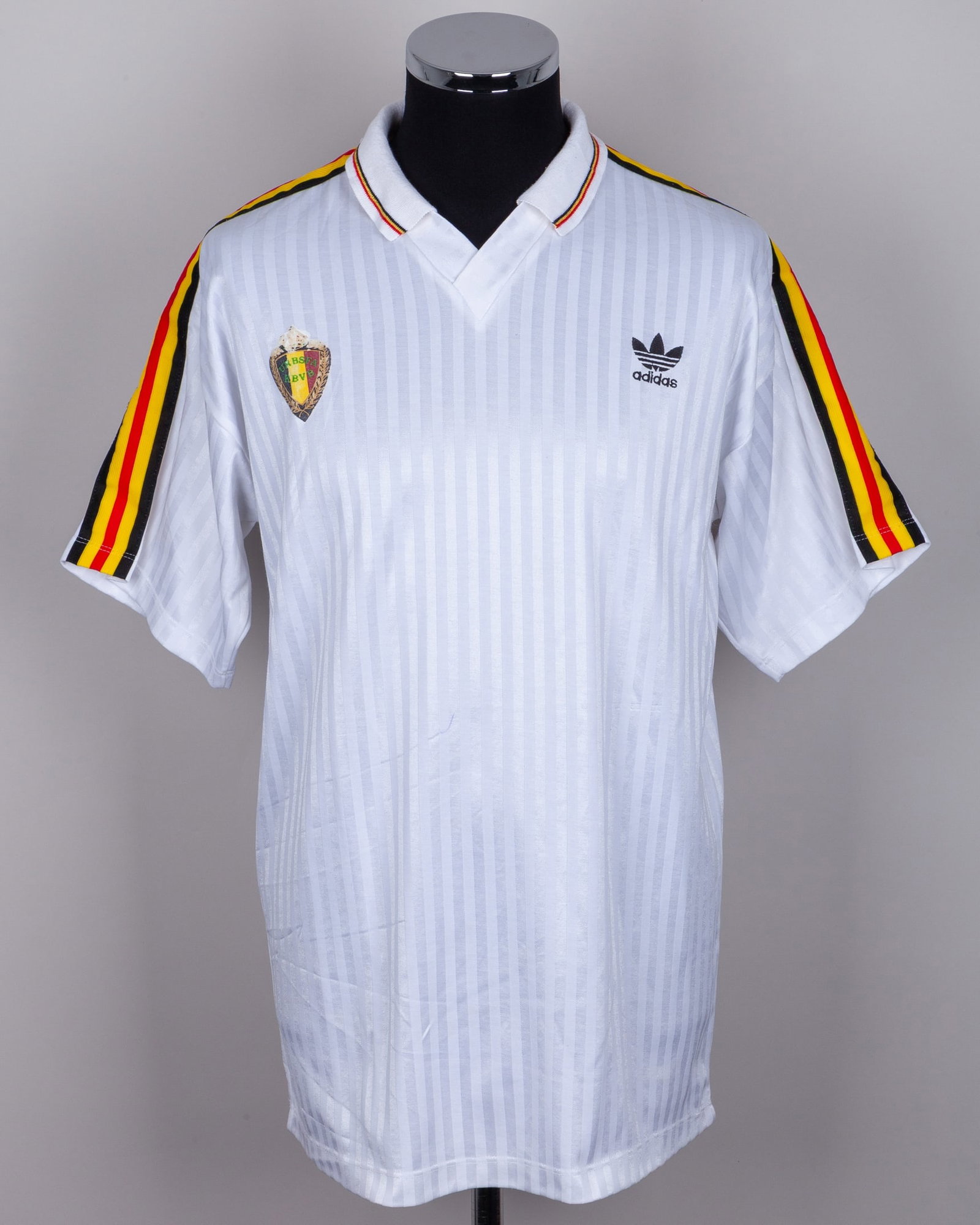 Belgium - Lei Clijsters white No.4 Belgium v. South Korea match worn shirt, 1990: Belgium - Lei Clijsters white No.4 Belgium v. South Korea World Cup match worn short-sleeved shirt, 1990, Adidas, EL, with v-neck collar and printed badge, wear to badge The above shirt was worn by Cl
