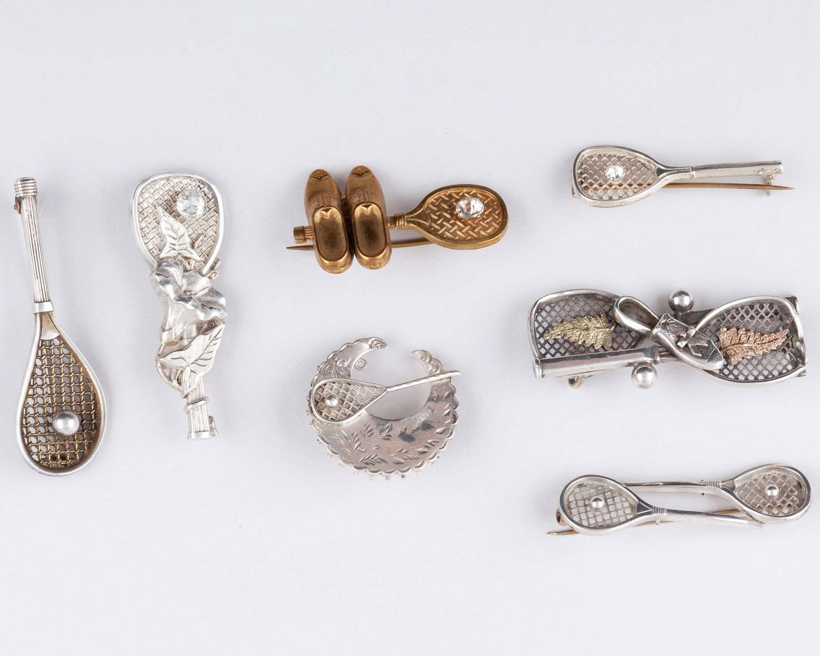 Two silver tennis related brooches, 1885 and 1890 (1 of 2)