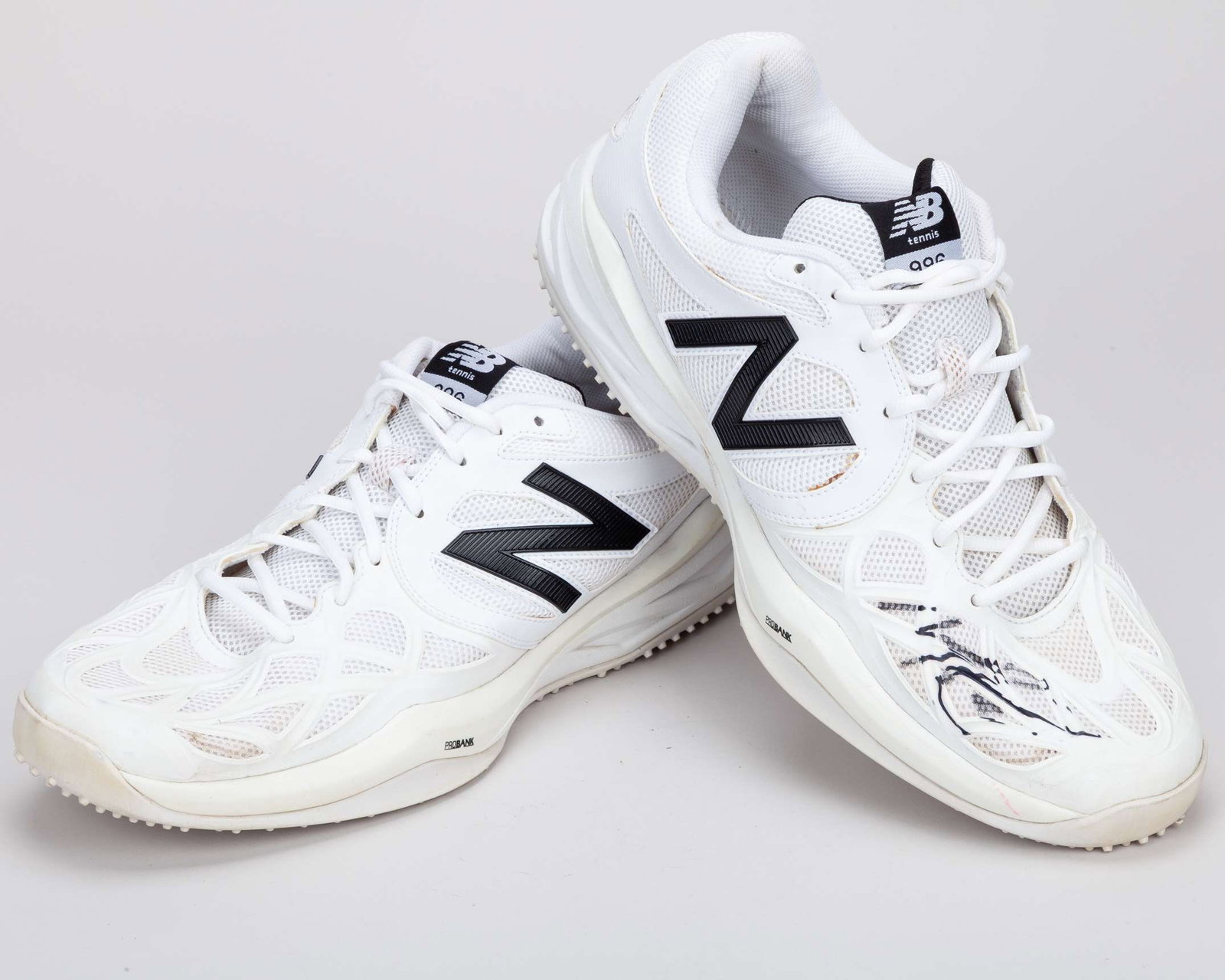 Milos Raonic pair of white and black New Balance 996 match worn tennis shoes, 2013: Milos Raonic pair of white and black New Balance 996 match worn autographed tennis shoes, 2013, size 14, each shoes autographed, signs of wear, the shoes were worn during the 2013 Championships, with 