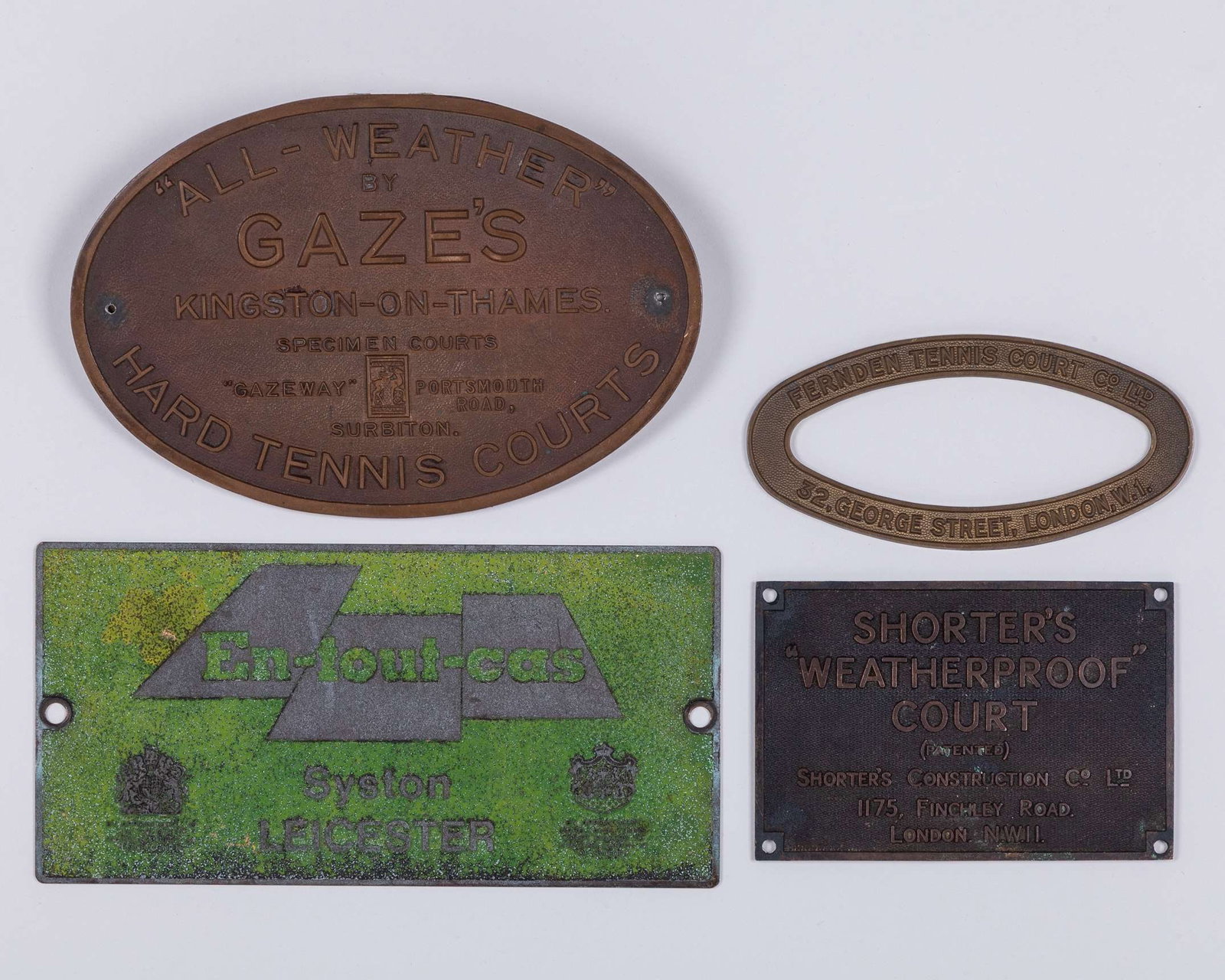 Four various tennis court plaques: Four various tennis plaques, comprising “All - Weather” by Gaze's, Kingston-On-Thames, Fernden Tennis Court, London, Shorter's “Weatherproof” Court, London, En-Tout-Cas,