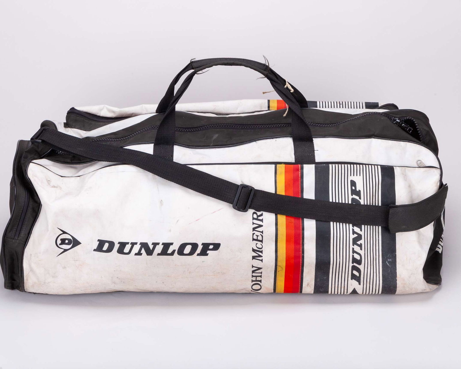 John McEnroe large white Dunlop equipment duffle bag: John McEnroe large white Dunlop equipment duffle bag, inscribed on the sides JOHN McENROE The bag was gifted to a staff member of the residency McEnroe would regularly stay at during