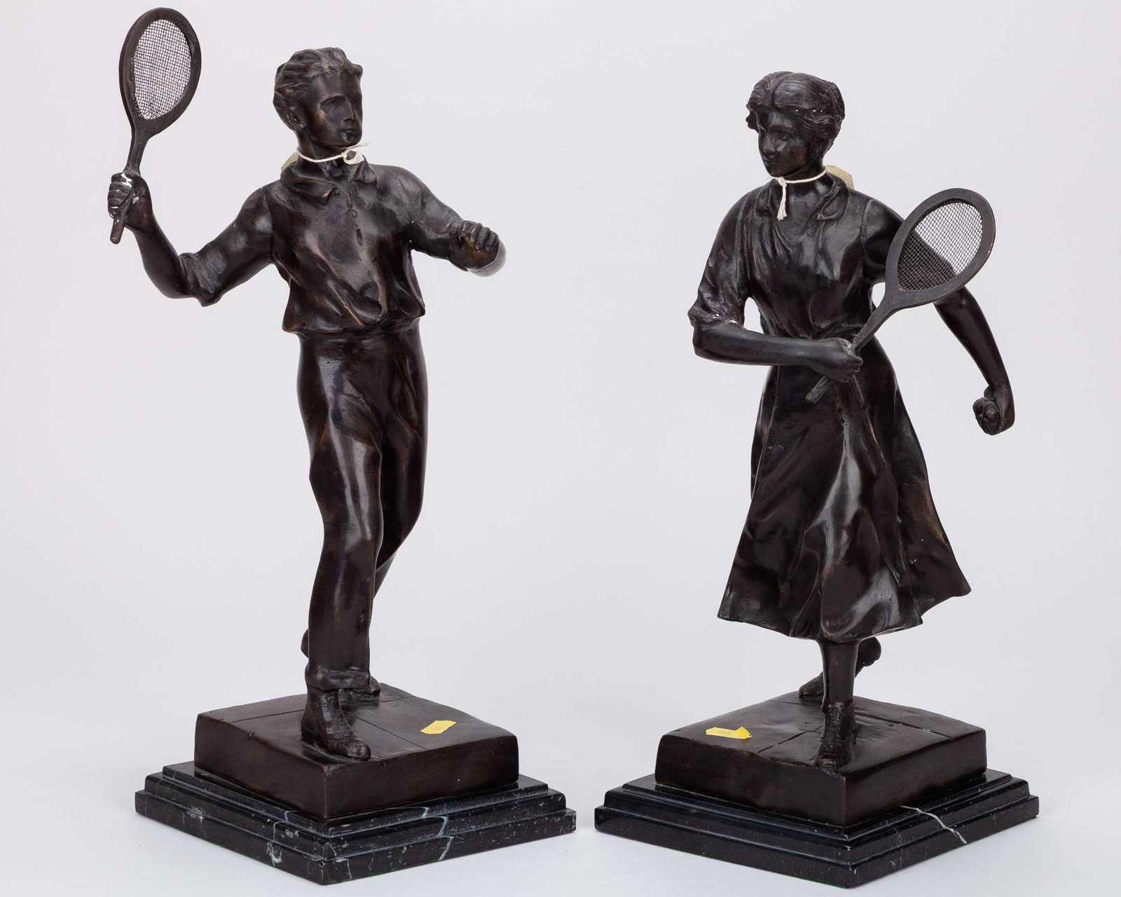 Pair of spelter 20th century tennis figures : Pair of spelter 20th century tennis figures, each holding a racquet, the base signed by the artist, 43cm high (2) 