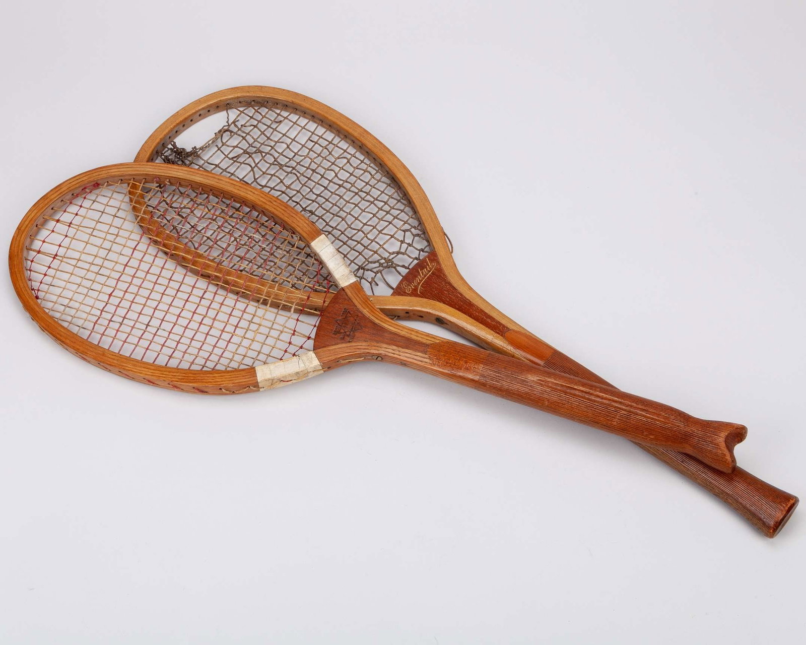 Two classic tennis rackets both with unusual handles: Two classic tennis rackets both with unusual handles, one with narrow head, “The Demon” fishtail racket by Slazenger's, with Demon patent logo and the Best is Best stamp, 70cm and an