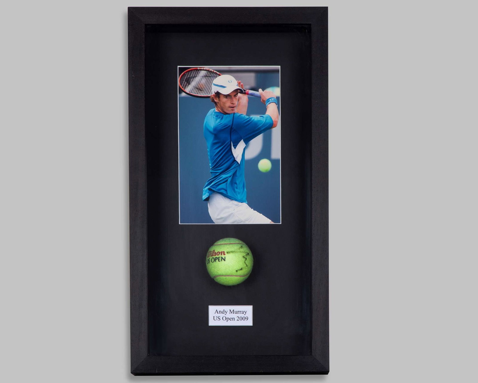 Andy Murray autographed Wilson US Open 2009 tennis ball display: Andy Murray autographed Wilson US Open 2009 tennis ball display, with colour photograph and paper plaque, framed and glazed, 28 x 50cm Depending on your location it may not be possible to ship t
