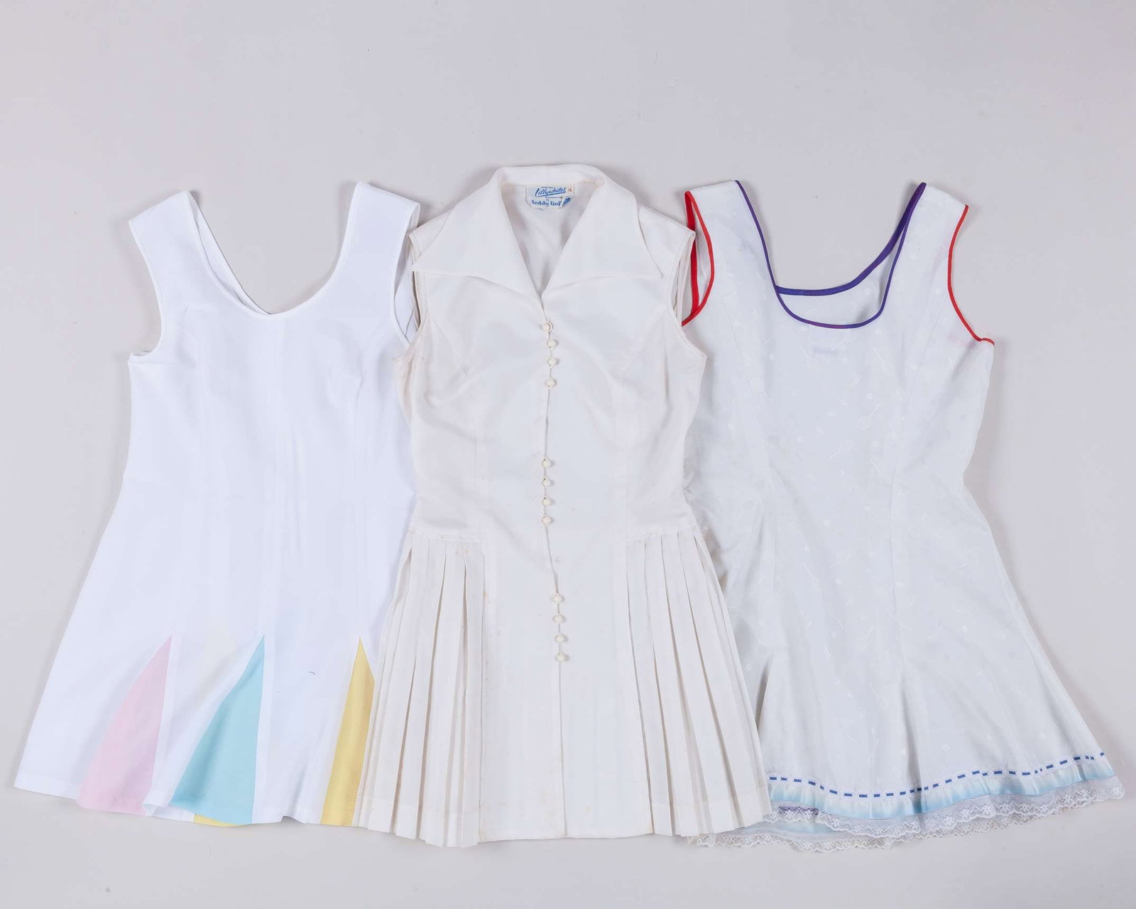 Five various Teddy Tinling designed tennis dresses: Five various Teddy Tinling designed tennis dresses, two size 14, one 16, one 18 and one without size, three for Lillywhite, one Harrods, with associated letter, each with areas of staining 