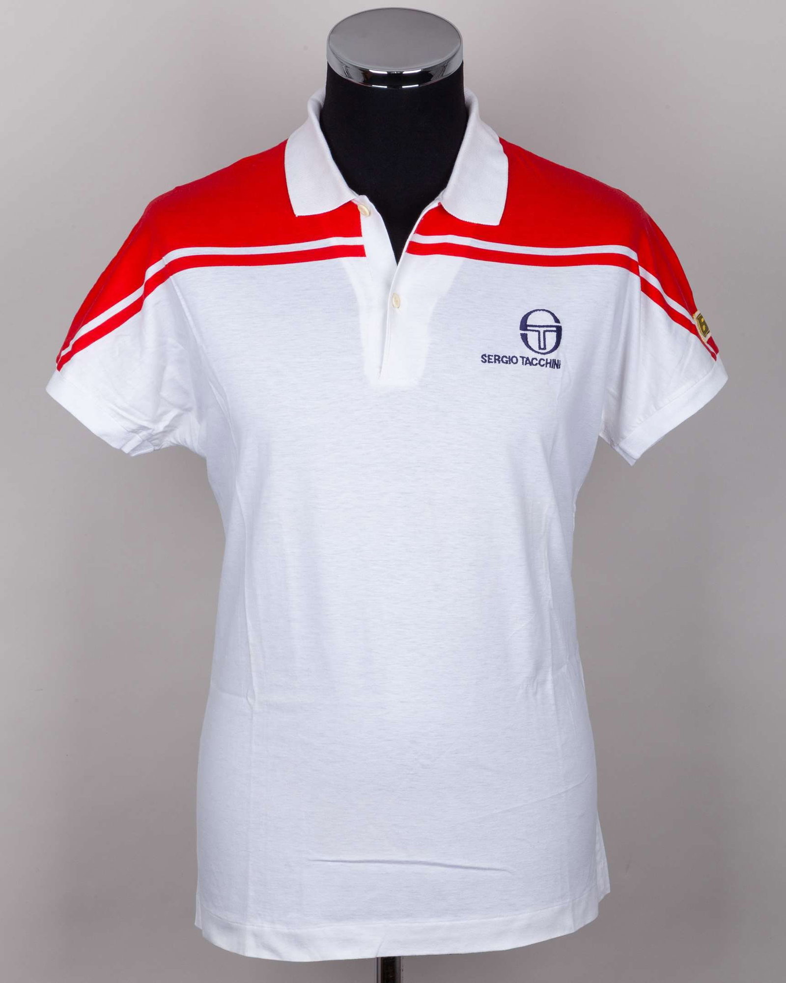 John McEnroe white and red Wimbledon tennis polo short-sleeved shirt, c.1983-84: John McEnroe white and red Wimbledon tennis polo short-sleeved shirt, c.1983-84, Sergio Tacchini The shirt was gifted to a staff member of the residency McEnroe would regularly stay at during