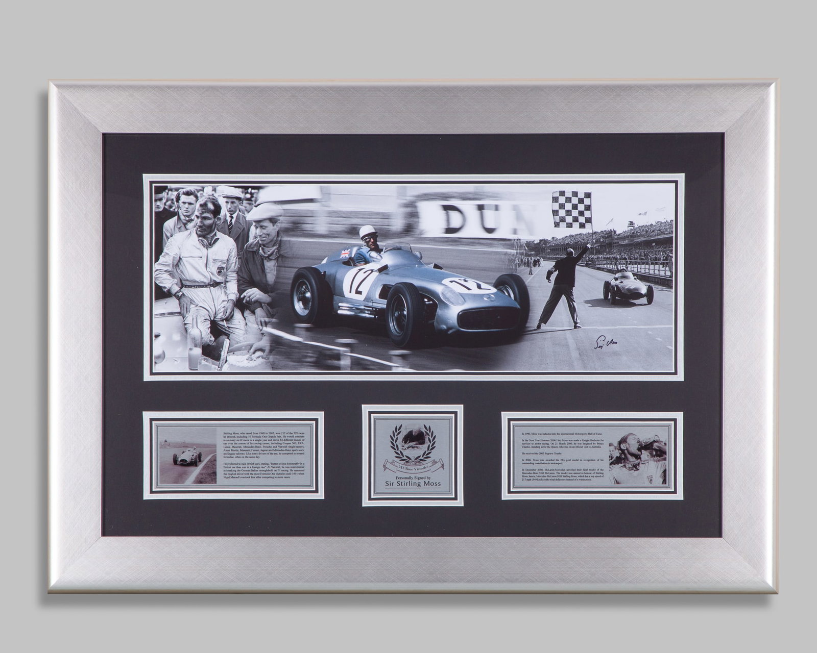 Stirling Moss Signed Framed Photo: Stirling Moss Signed Framed Photo.The photo is hand signed by legendary British racing driver Sir Stirling Moss. Professionally mounted and framed with 3 x detailed plaque descriptions.Complete with a