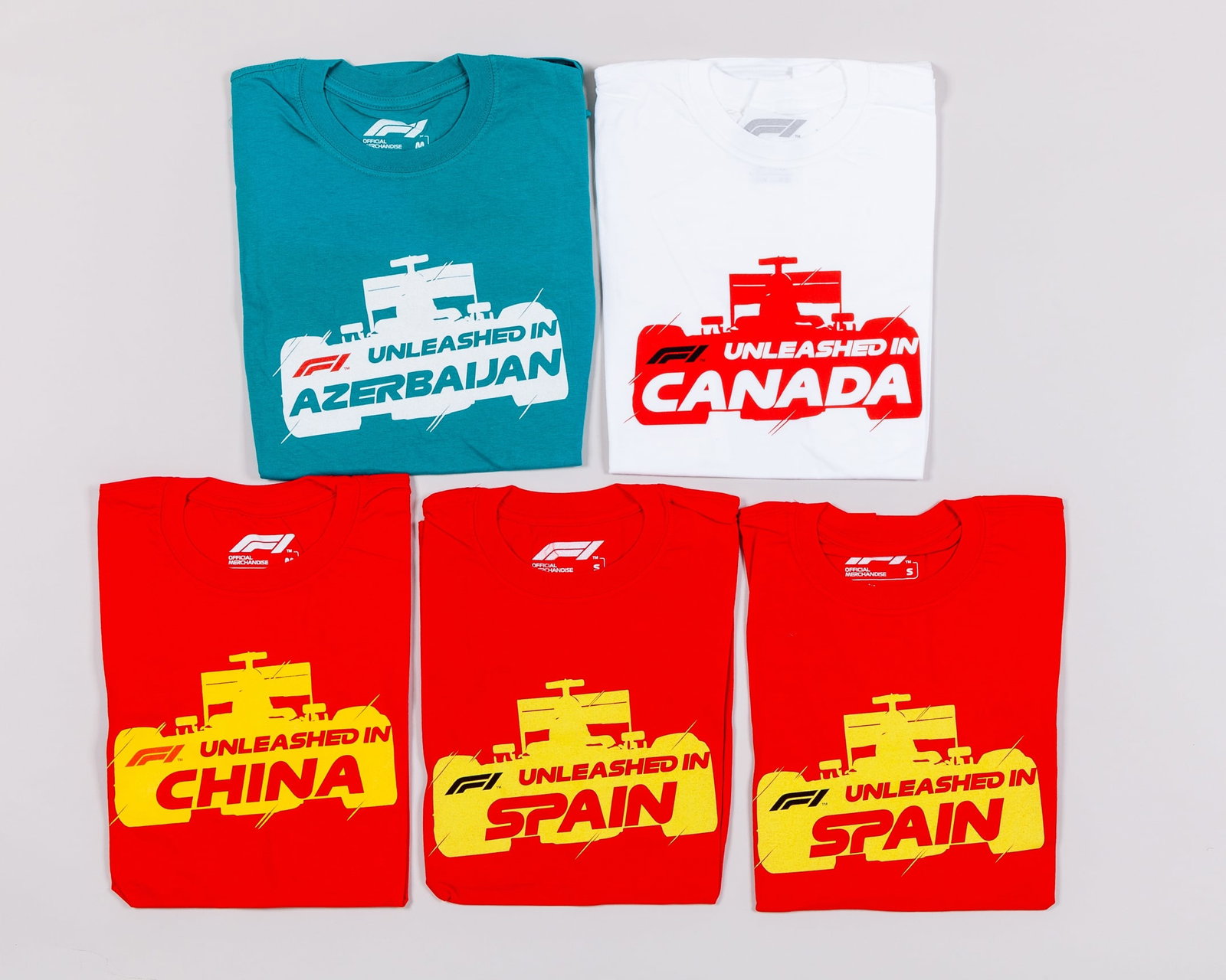 Five F1 Unleashed T-Shirts (New): Five F1 Unleashed T-Shirts (New).This collection includes the following:F1 Unleashed T-Shirt - Azerbaijan - size mediumF1 Unleashed T-Shirt - Canada - size mediumF1 Unleashed T-Shirt - China - size me