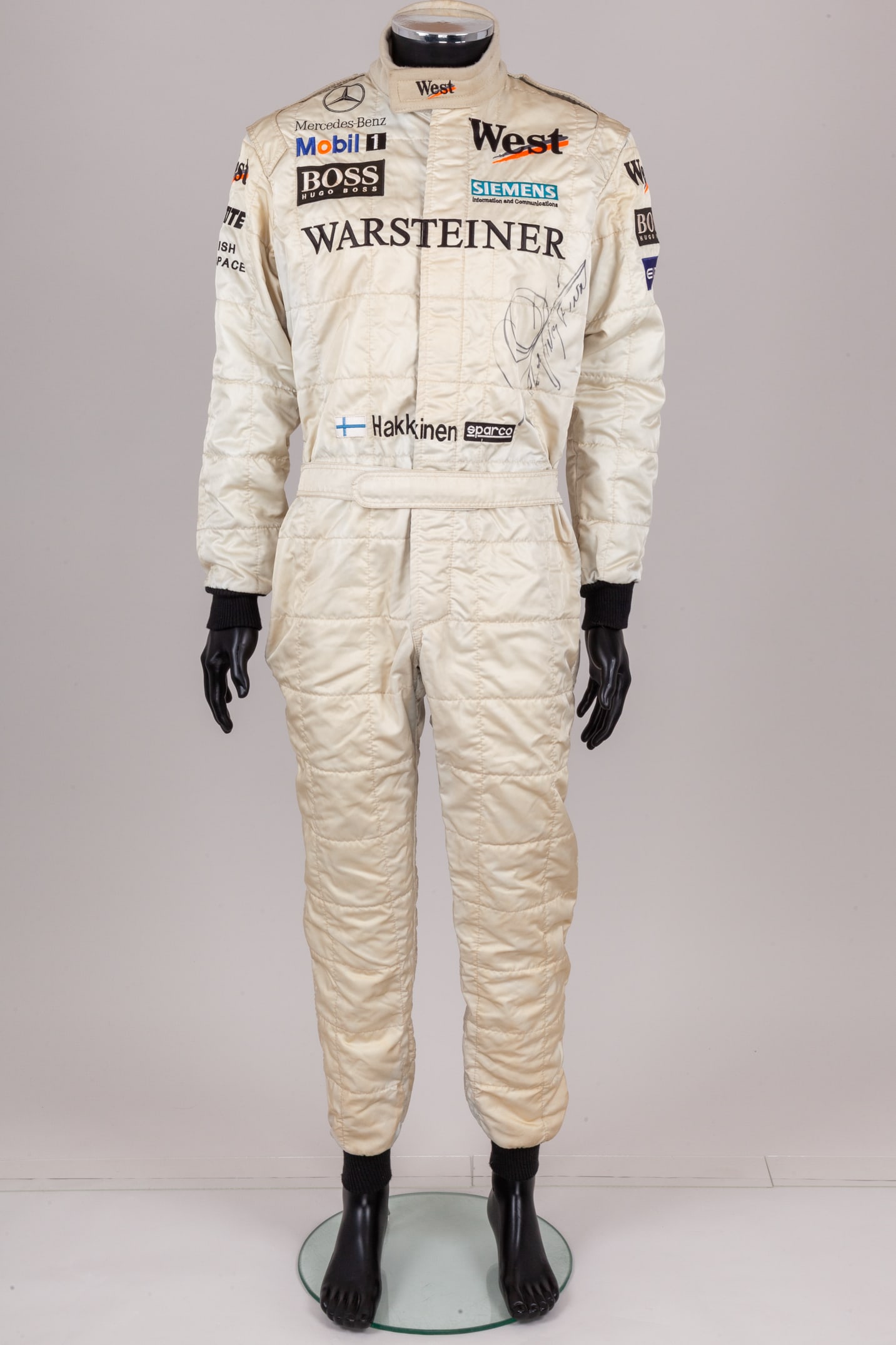 Mika Hakkinen Signed McLaren Replica Race Suit: Mika Hakkinen Signed McLaren Replica Race Suit.This McLaren replica race suit has been personally signed by the 2-time F1 World Champion.The detailed replica race suit features authentic McLaren styli