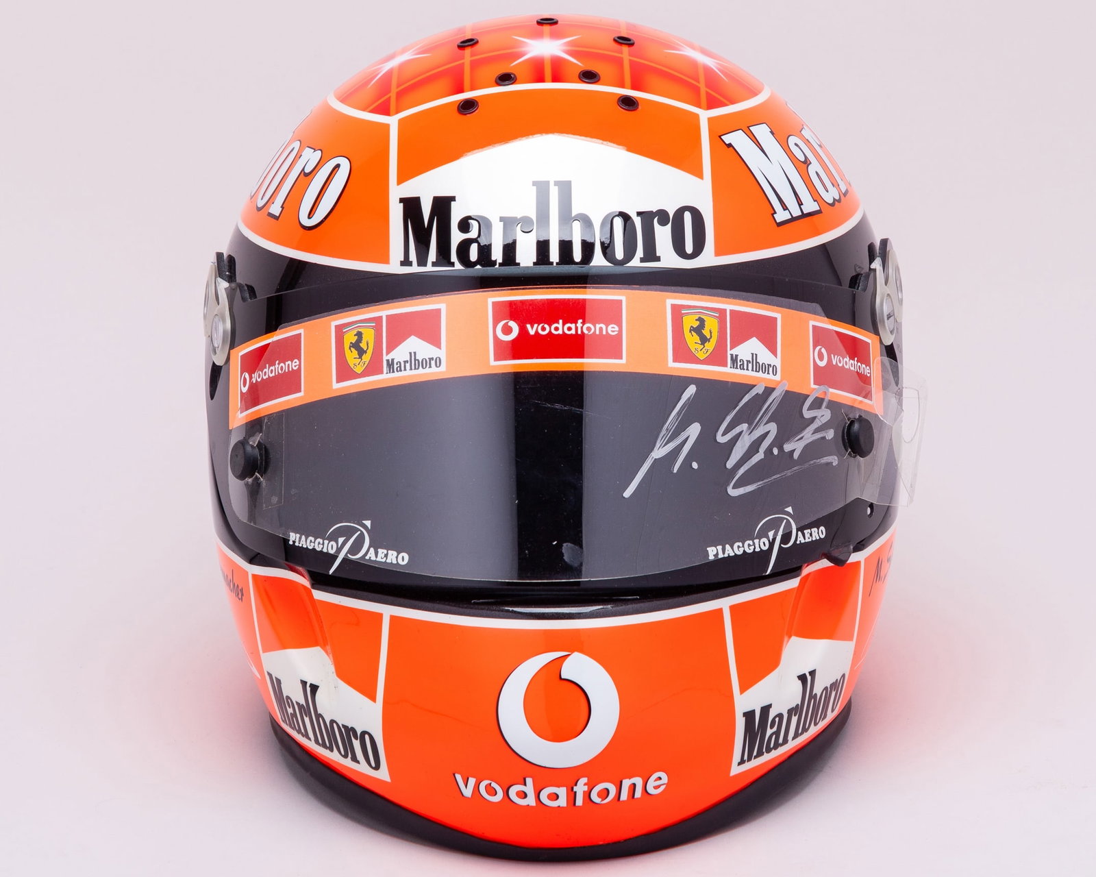 Michael Schumacher Signed Ferrari Schuberth Replica Helmet: Michael Schumacher Signed Ferrari Schuberth Replica Helmet.This striking Schuberth replica helmet captures the iconic design associated with Schumacher's illustrious racing career.The helmet is person