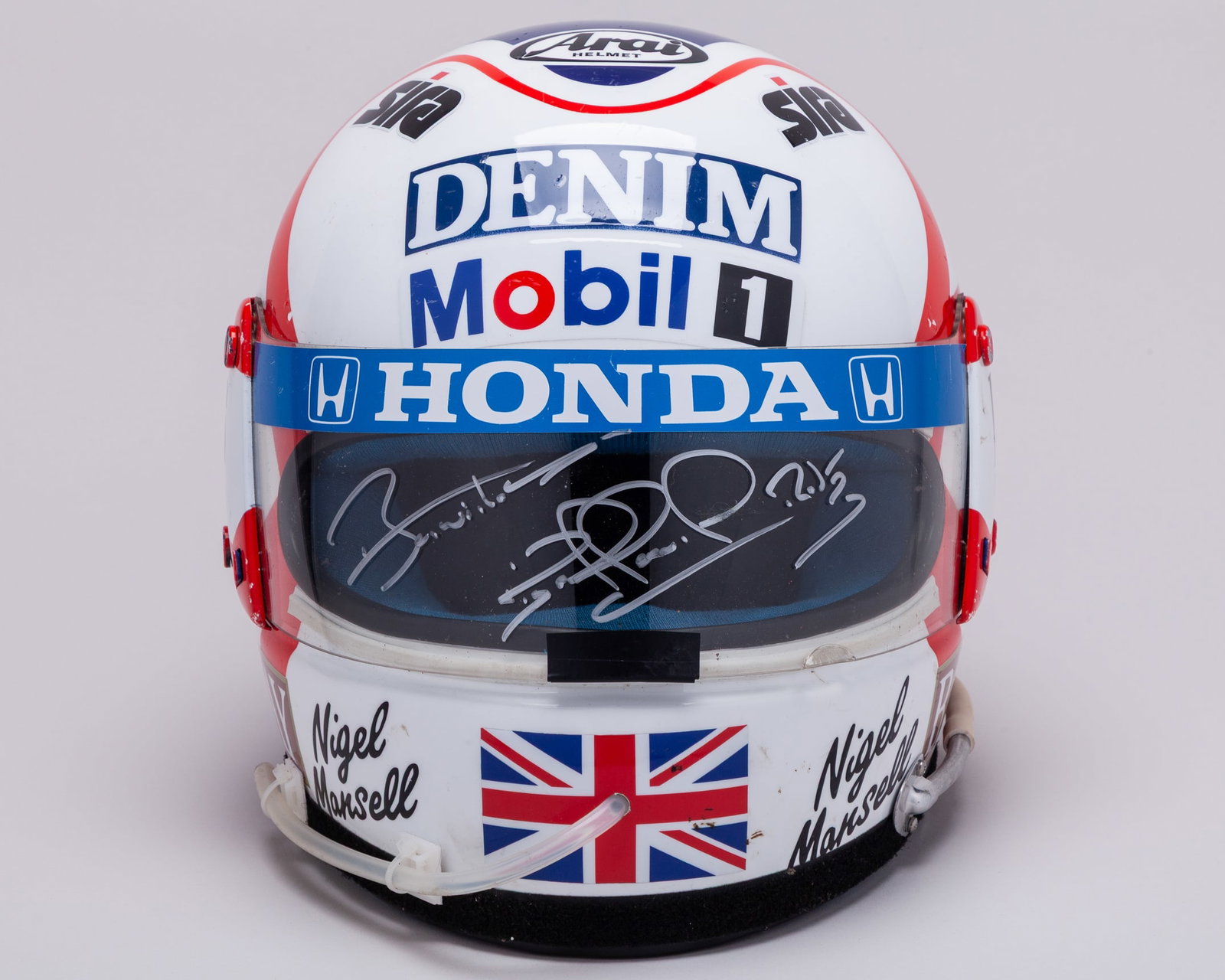 Nigel Mansell 1987 Canon Williams Honda Signed Race Used Helmet with Gloves: Nigel Mansell 1987 Canon Williams Honda Signed Race Used Helmet with Gloves.This race used helmet and glove set was worn by the 1992 F1 World Champion during the 1987 Formula One season while competin