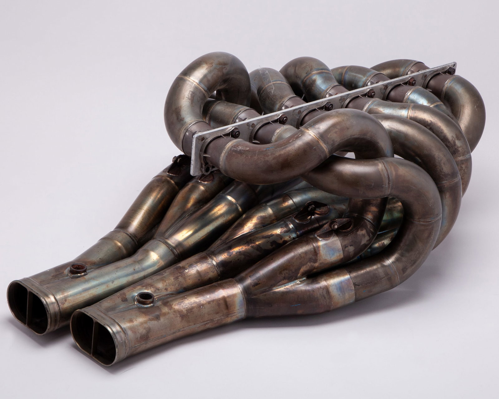 Ferrari V12 Race Used Exhaust Manifold: Ferrari V12 Race Used Exhaust Manifold.This is a genuine race-used Ferrari Formula One V12 exhaust manifold. During the V12 era, Ferrari engines were renowned for their high-revving character and icon