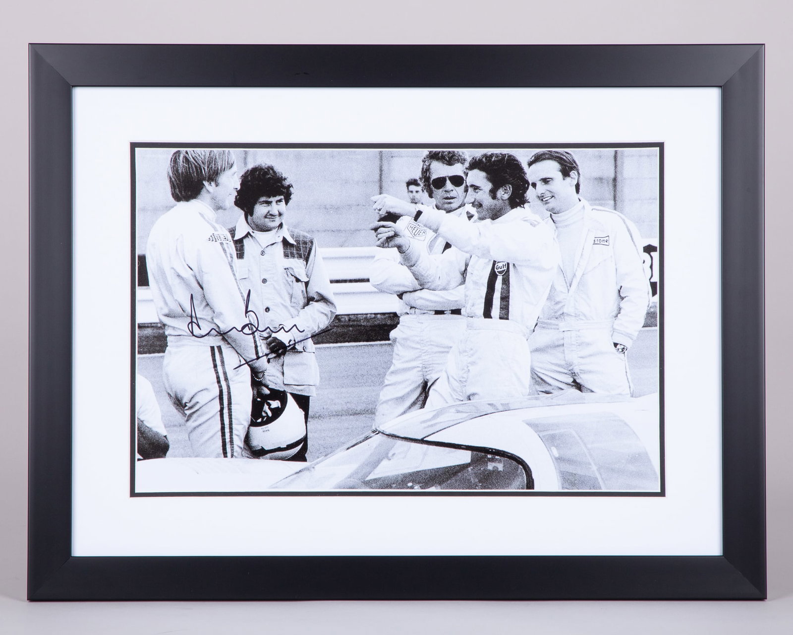 Steve McQueen Framed Black & White Filming Photo Signed by Derek Bell: Steve McQueen Framed Black & White Filming Photo Signed by Derek Bell.The photograph has been personally signed by Derek Bell, the 5-time Le Mans winner and one of endurance racing's most celebrated d