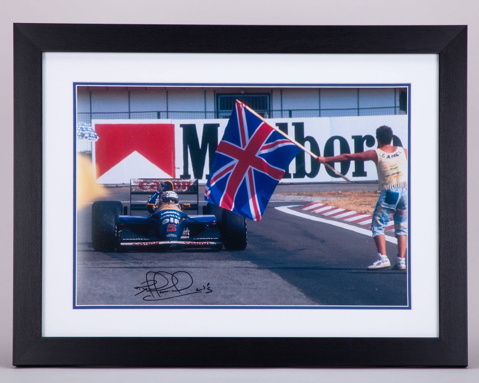 Nigel Mansell Signed Williams Renault Framed Photo: Nigel Mansell Signed Williams Renault Framed Photo.This photo is personally signed by the 1992 Formula 1 World Champion.The frame measures 61cm length x 46cm width. Framed and glazed.Depending on your