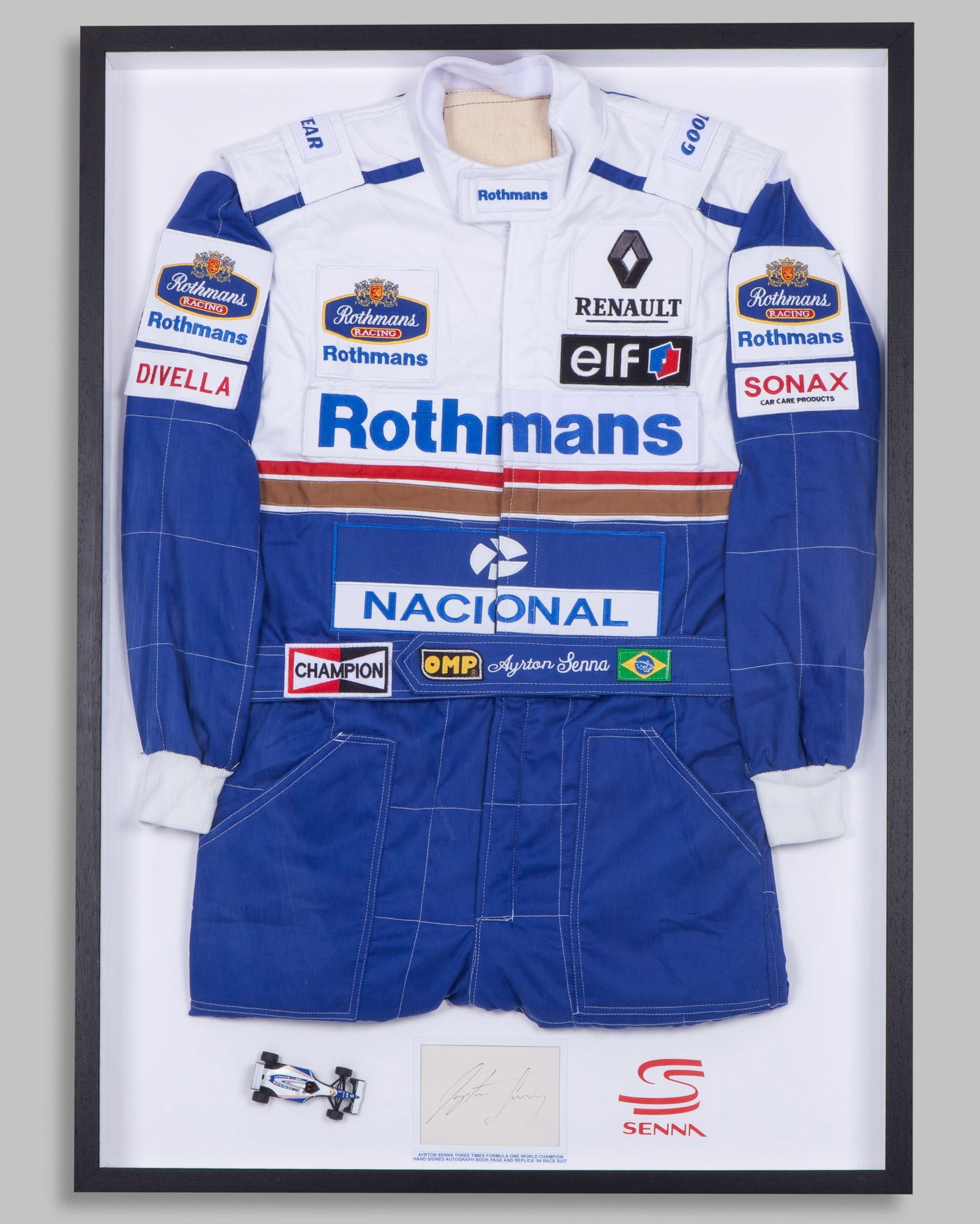 Ayrton Senna 1994 Williams Renault Replica Race Suit Framed Display with Signature: Ayrton Senna 1994 Williams Renault Replica Race Suit Framed Display with Signature.This is a replica race suit of Ayrton Senna?s 1994 Williams Renault, combined in a frame with a signed autograph page
