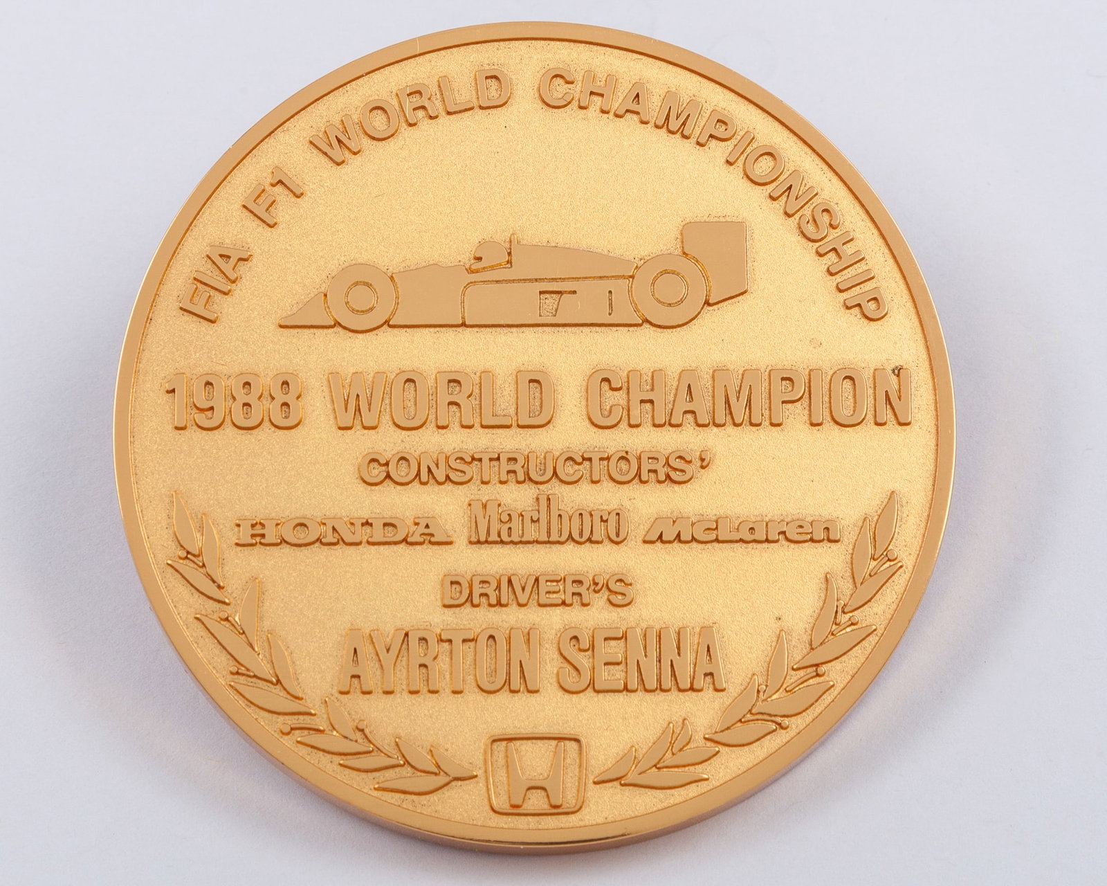Ayrton Senna Yellow-Metal 1988 McLaren Team Championship Medal: Ayrton Senna Yellow-Metal 1988 McLaren Team Championship Medal.?The obverse inscribed FIA F1 WORLD CHAMPIONSHIP, 1988 WORLD CHAMPION CONSTRUCTORS, HONDA, MARLBORO MCLAREN Driver's AYRTON SENNA, the re