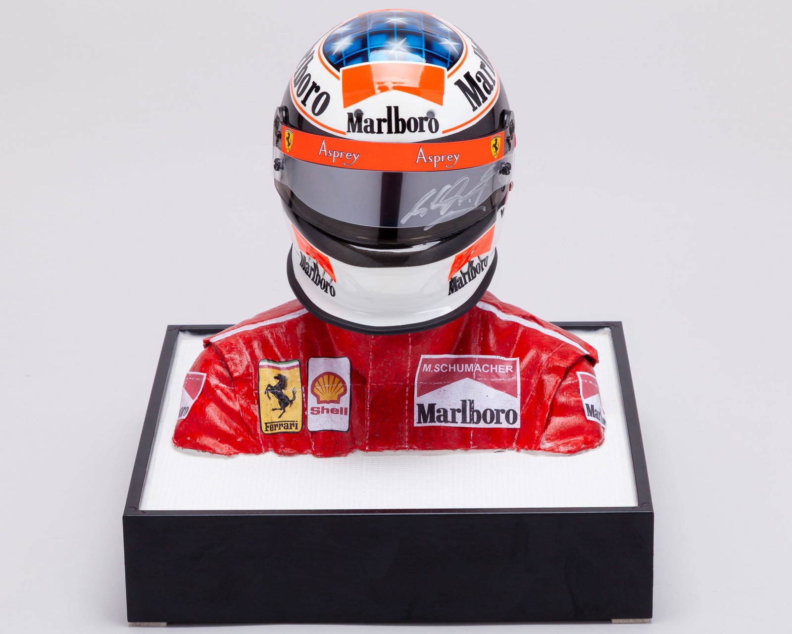 Michael Schumacher 1996 Signed Ferrari 1:2 Scale Helmet Display: Michael Schumacher 1996 Signed Ferrari 1:2 Scale Helmet Display.Personally signed by the 7-time F1 World Champion, representing the iconic duo of Schumacher and Ferrari.Complete with driver mannequin 