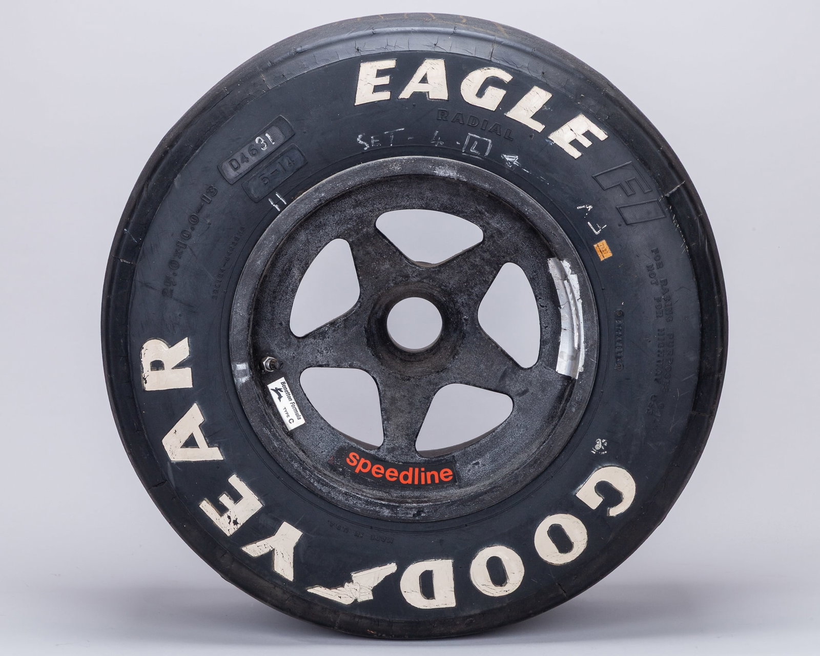 Benetton Used Goodyear Eagle Front Wheel & Tyre: Benetton Used Goodyear Eagle Front Wheel & Tyre.The wheel features authentic race wear consistent with track use, adding to its provenance and visual appeal.Bearing its original ?Benetton Formula ? Ty