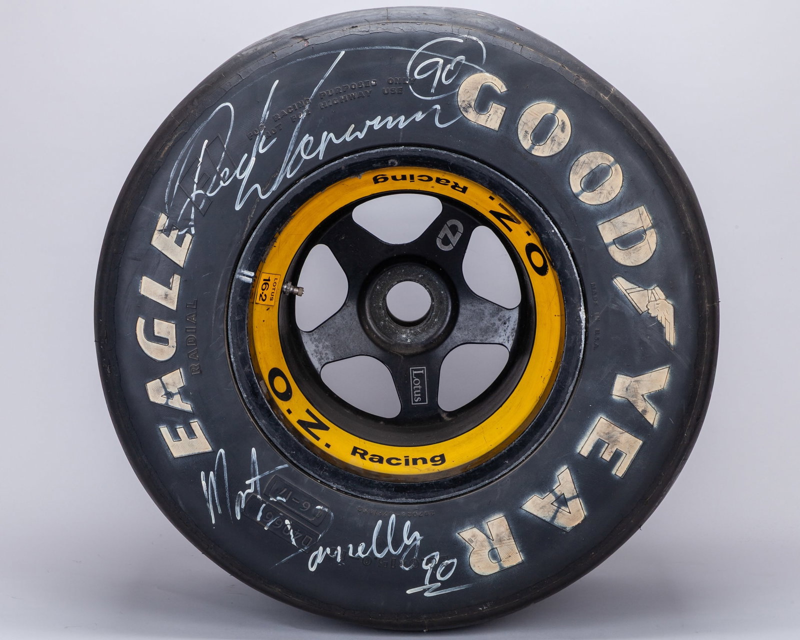 Goodyear Eagle Used Rear Wheel & Tyre Signed by Derek Warwick & Martin Donnelly: Team Lotus Goodyear Eagle Used Rear Wheel & Tyre Signed by Derek Warwick & Martin Donnelly.The wheel features authentic race wear consistent with track use, adding to its provenance and visual appeal.