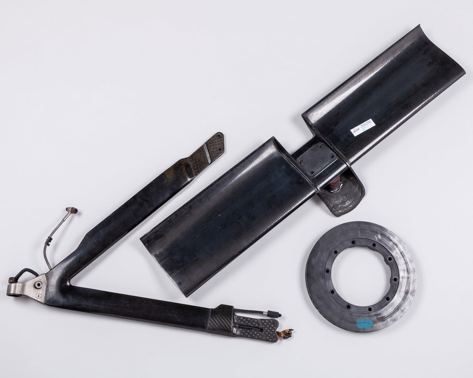 Jaguar Racing Car Parts: Jaguar Racing Car Parts.The collection of car parts include:Rear wing plane - part number is R3-WI-002-3B #023.Wishbone - part number is R3-FS-467-01 #001.Brake Disc.