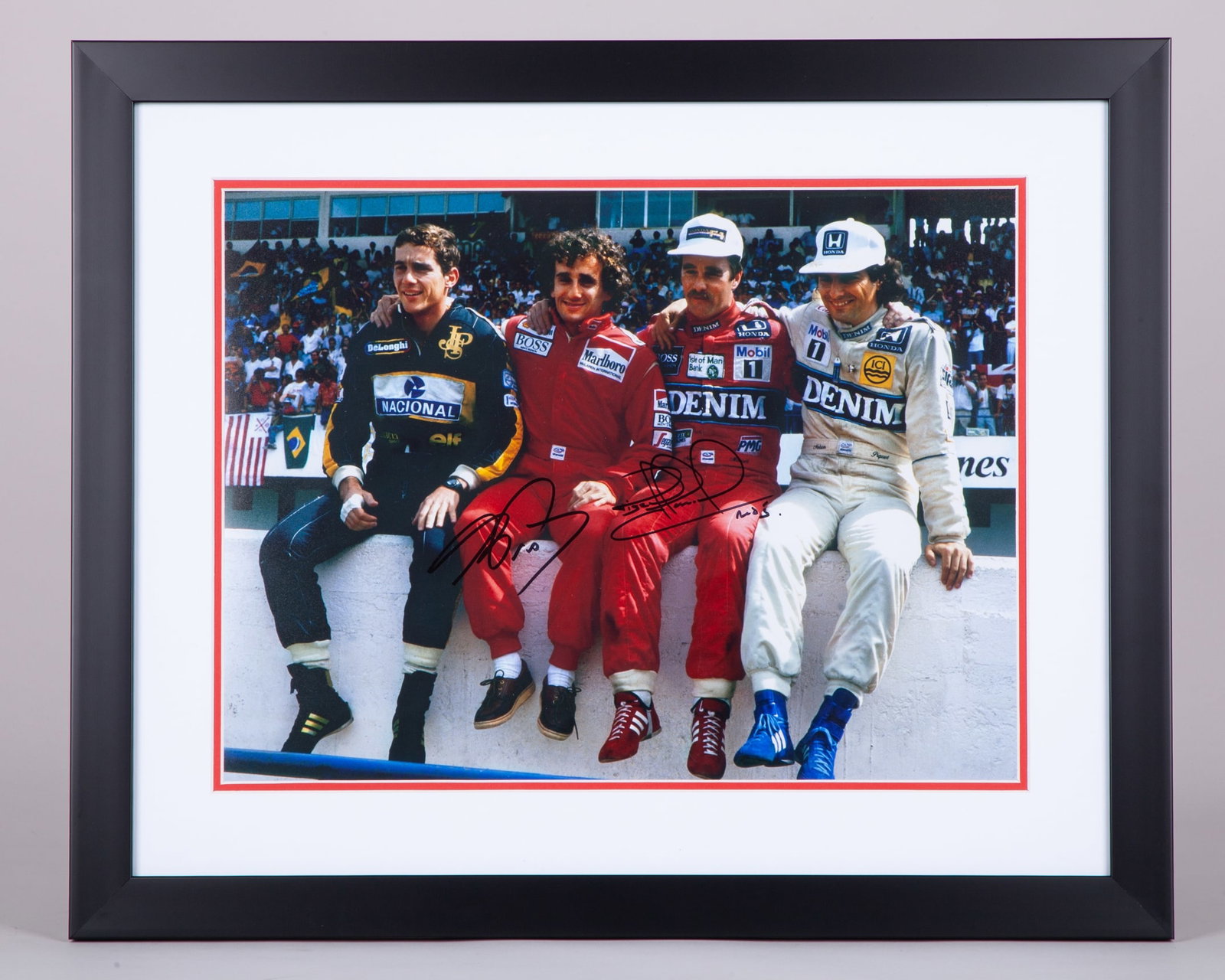 “Wall of Champions” Framed Print Signed by Nigel Mansell & Alain Prost: “Wall of Champions” Framed Print Signed by Nigel Mansell & Alain Prost. The print captures the iconic moment with F1 World Champions Ayrton Senna, Nigel Mansell, Alain Prost, and Nelson Piquet