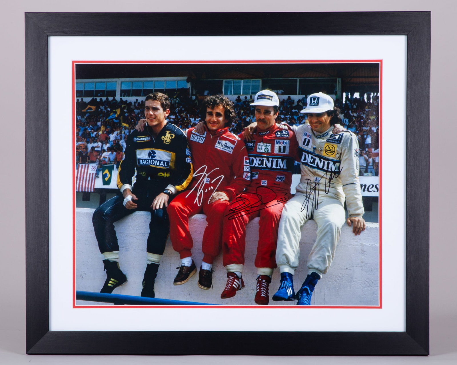 “Wall of Champions” Framed Print Signed by Nigel Mansell, Alain Prost & Nelson Piquet: “Wall of Champions” Framed Print Signed by Nigel Mansell, Alain Prost & Nelson Piquet. The print captures the iconic moment with F1 World Champions Ayrton Senna, Nigel Mansell, Alain Prost, an