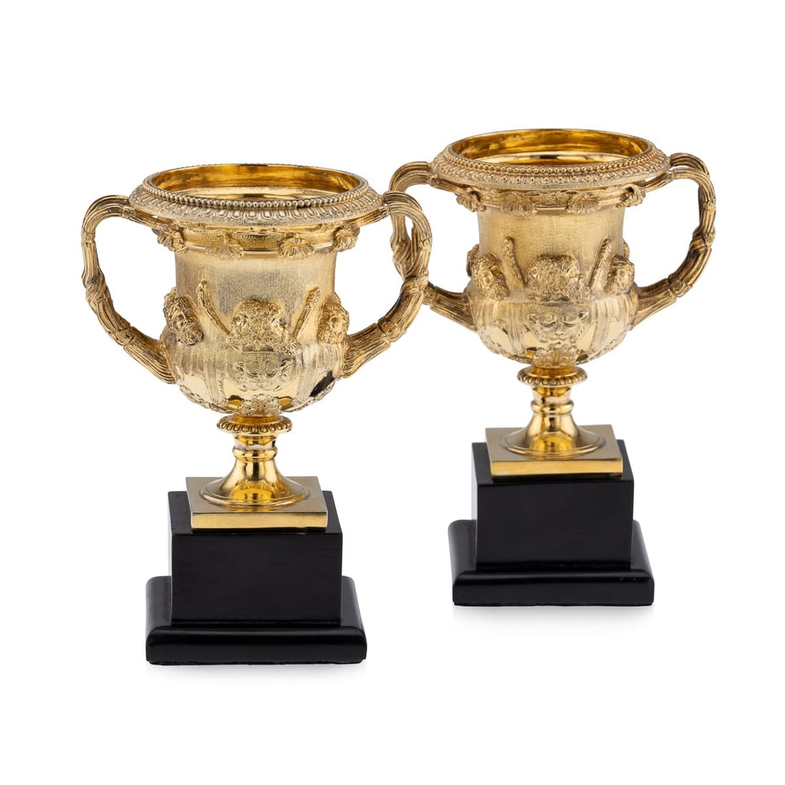 ANTIQUE 20thC BRITISH PAIR OF SOLID SILVER-GILT WARWICK VASES, ASPREY c.1914: Antique early 20th Century exceptionally rare pair of solid silver gilt Warwick vases. Of typical form with acanthus leaf decoration on square ebonised bases. The sides applied with classical heads