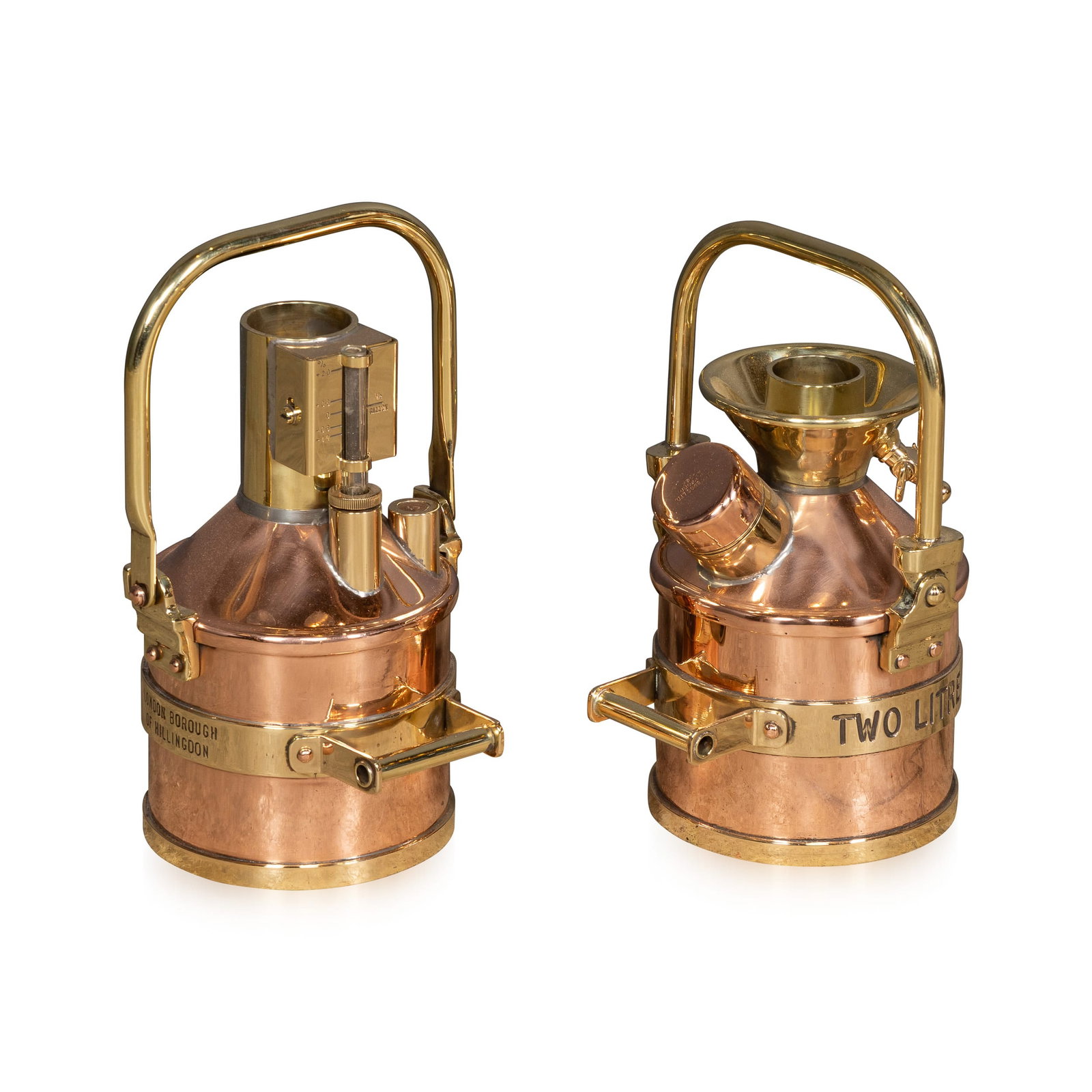 VINTAGE 20thC ENGLISH PAIR OF POLISHED CHECKPUMP PETROL CANISTERS c.1970: Vintage 20th Century pair of polished brass and copper petrol measuring canisters, once used at the pump by the London Borough of Hillingdon Council. Manufactured by Wragg Bros Ltd, these pieces