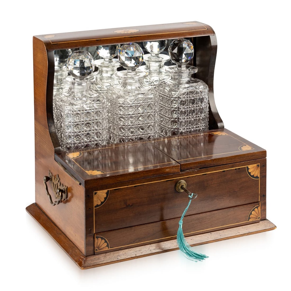 ANTIQUE 20thC ENGLISH TANTALUS WITH GAMES COMPENDIUM: This exquisite early 20th-century English tantalus combines the luxury of fine spirits storage with the charm of a built-in games compendium. Crafted from richly grained mahogany and adorned with deli