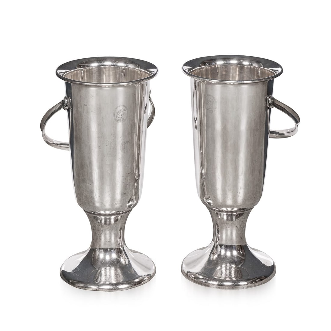 VINTAGE 20thC PAIR OF ENGLISH FLOOR STANDING SILVER PLATED WINE COOLERS: A striking pair of tall, floor-standing wine coolers in polished metal, likely dating to the mid 20th Century and designed with both practicality and visual presence in mind. Their elegant, elongated