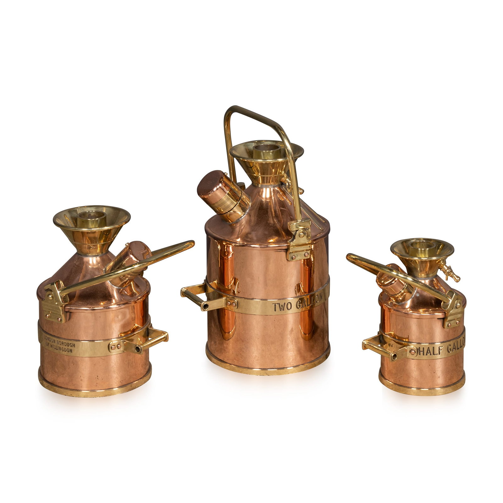 VINTAGE 20thC ENGLISH SET OF THREE POLISHED CHECKPUMP PETROL CANISTERS c.1965: Vintage 20th Century set of three petrol measuring canisters, used by the London Borough of Hillingdon Council to check the accuracy of fuel pumps. Made from polished brass and copper, the set