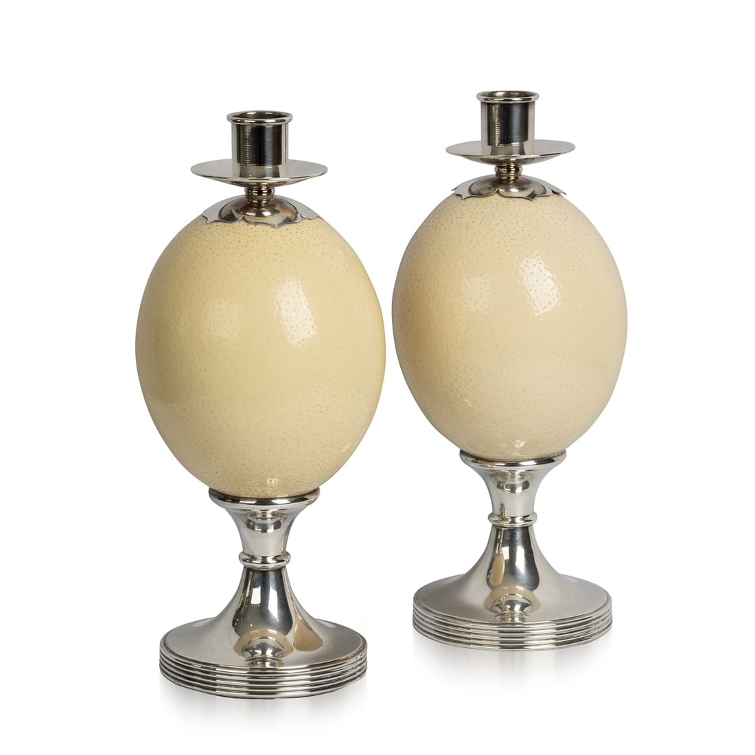 PAIR OF OSTRICH EGG MOUNTED SILVER PLATE CANDLESTICKS, ANTHONY REDMILE c.1970: A pair of ostrich egg candlesticks with silver plated mounts by Anthony Redmile. Impressed and signed Redmile London, retailed in his shop and purchased in the 1970s. Anthony Redmile burst into the Lo