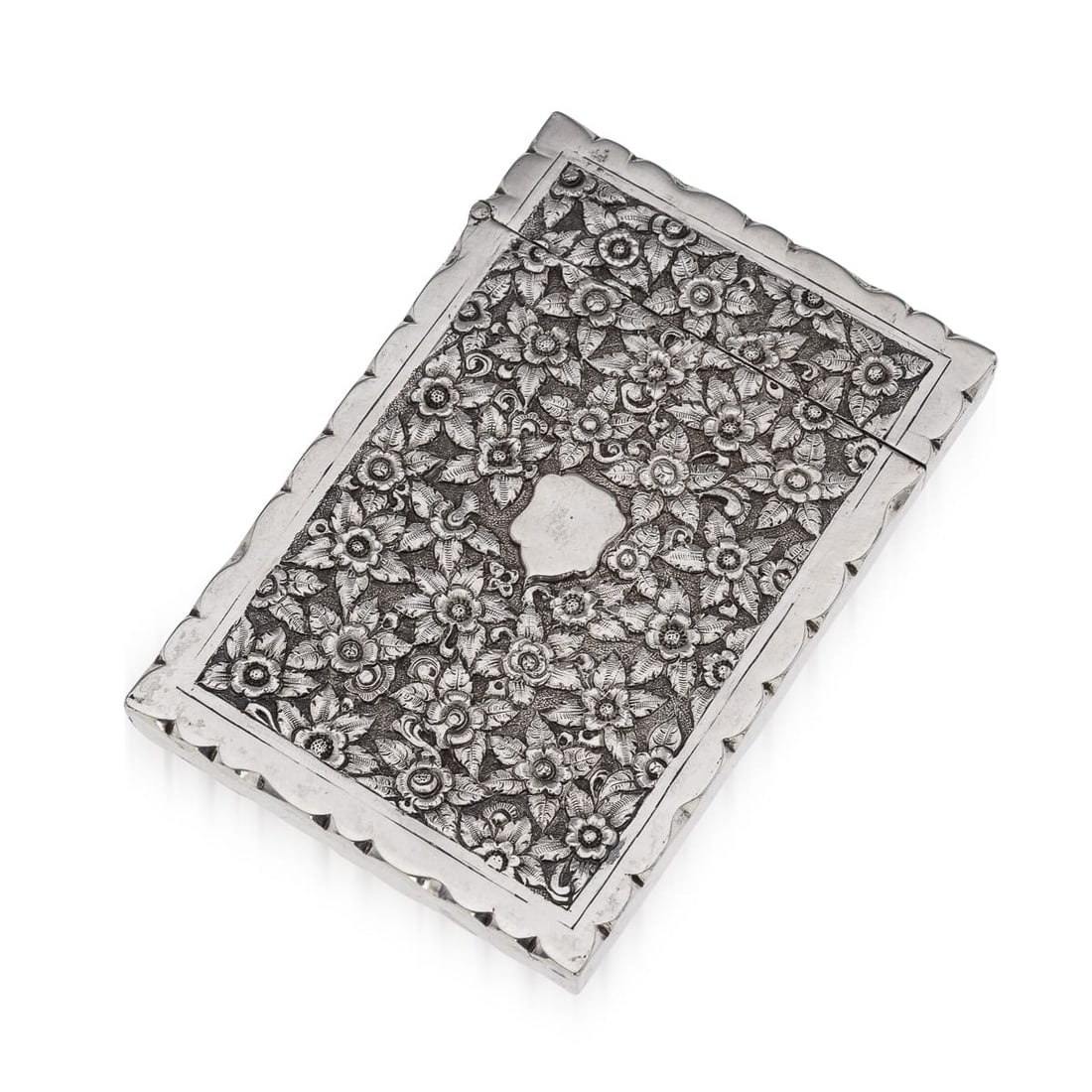 ANTIQUE 19thC INDIAN KUTCH SOLID SILVER CIGARETTE CASE c.1890: Antique 19th Century Indian Kutch solid silver cigarette case of heavy gauge, featuring intricate floral repoussé work on a matted background. The rectangular case has engraved edges resembling