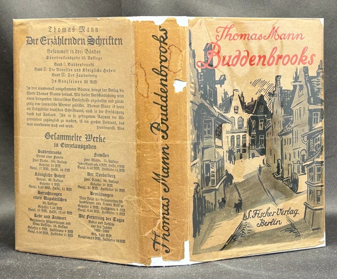 Thomas Mann: Buddenbrooks, 1930 German edition in rare dust jacket: Berlin: S. Fischer Verlag, 1930. Later printing. Cloth in pictorial dust jacket, book very good, early ownership signatures on title page, jacket good with some wear, loss and stains along spine, ligh