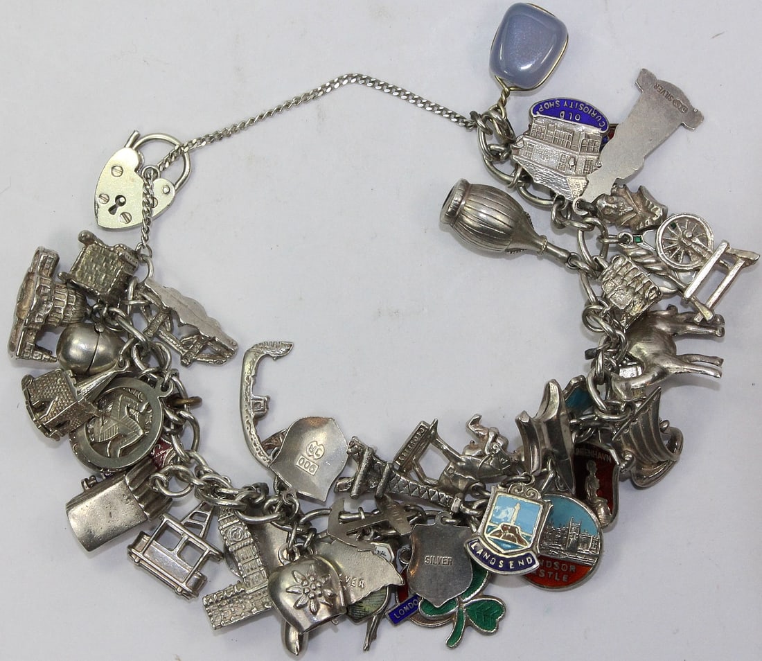 Charm Bracelet in Sterling (925) Silver with over 50 attached Charms: A well travelled owner Size ASW 2.5 Troy oz : Total Weight 84.29 grams Medium Bracelets Exhibited Charms