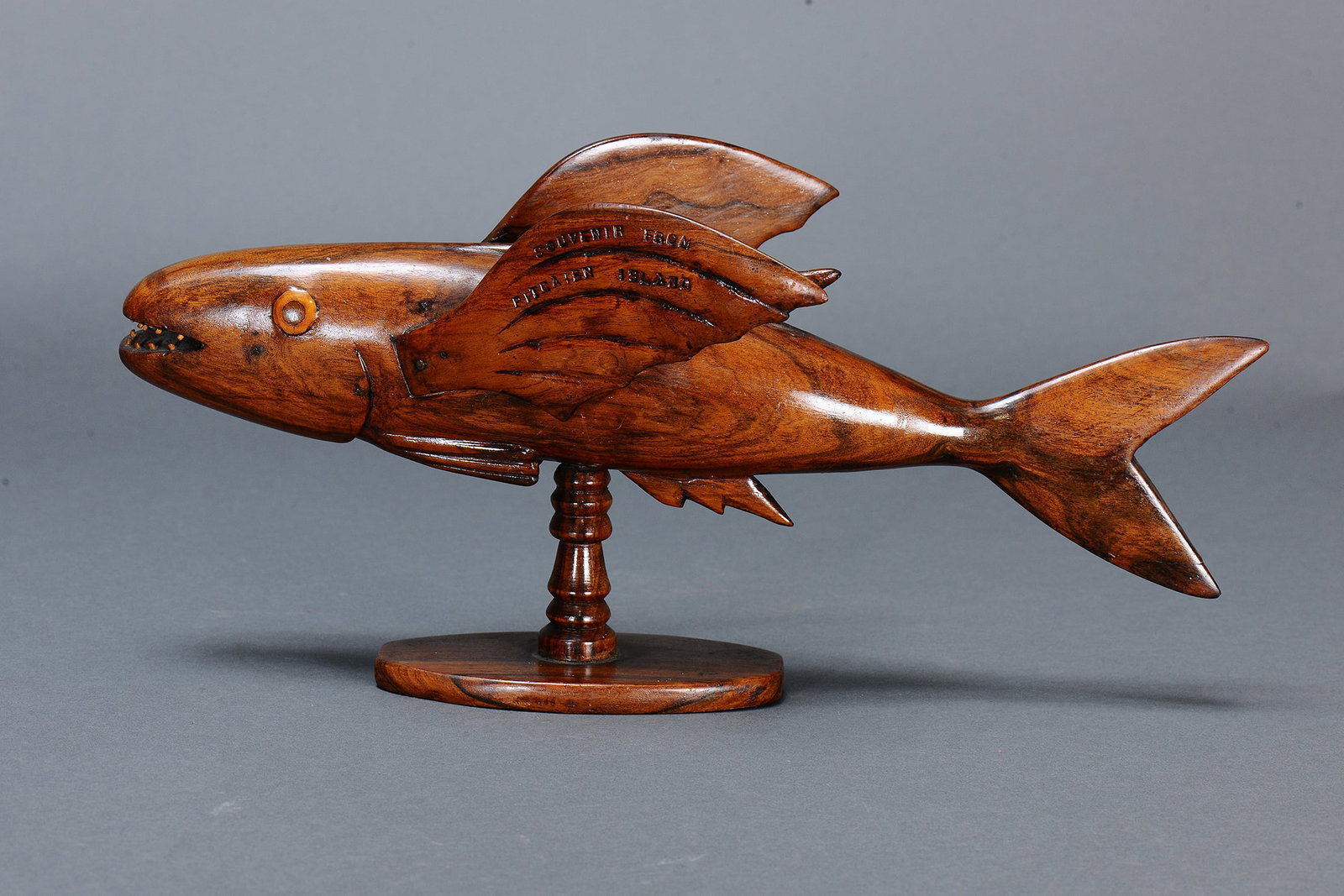 EARLY CHRISTIE WARREN FLYING FISH SCULPTURE, PITCAIRN ISLAND: Early Christie Warren Flying Fish sculpture, Pitcairn Island. Carved and engraved hardwood. Size Approx L42 x 20.5cm. Medium Indigenous Artifacts Provenance Made by Christie Warren, 1940s “S