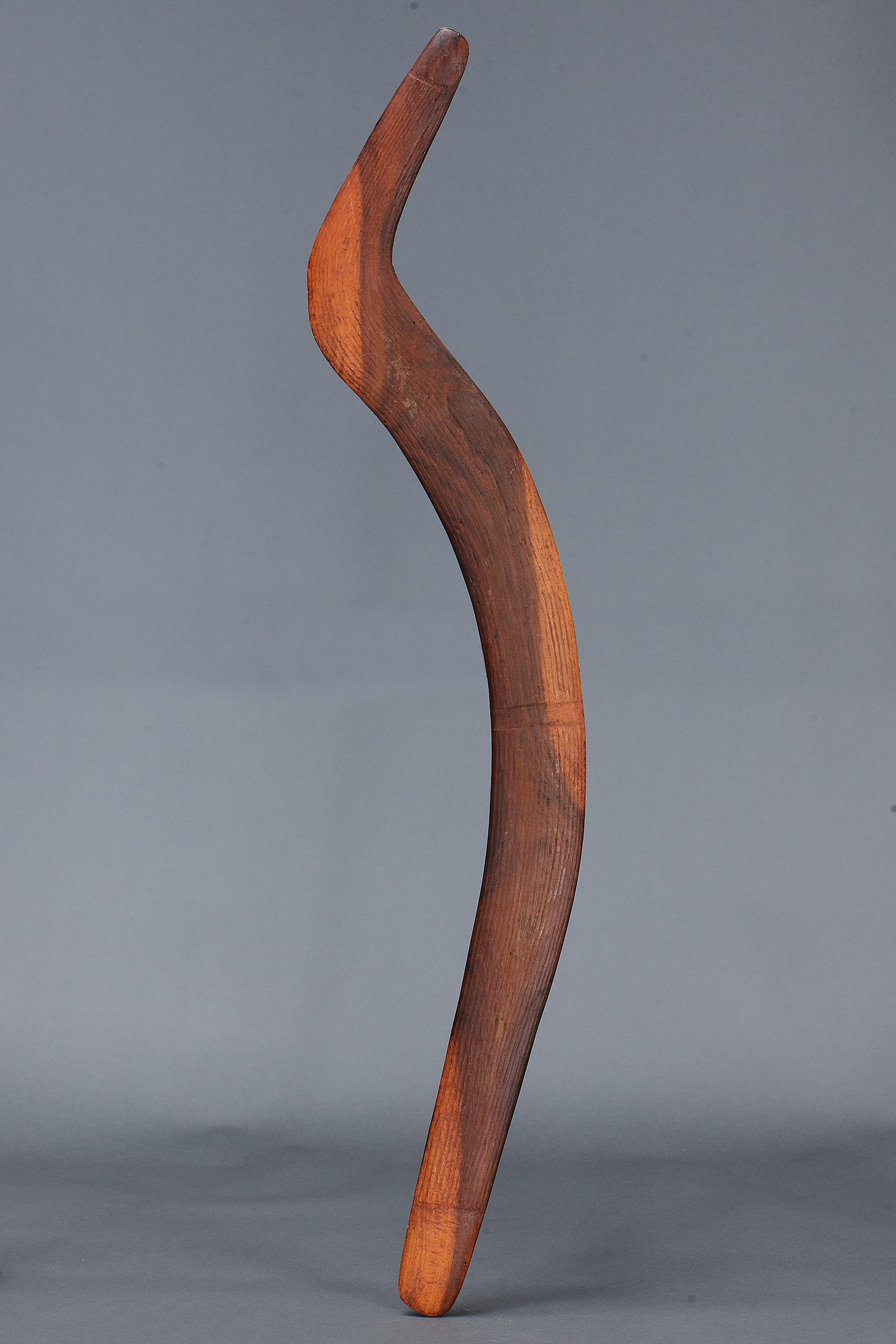 UNUSUAL LARGE HOOKED BOOMERANG, CENTRAL AUSTRALIA, NORTHERN TERRITORY: Unusual Large Hooked Boomerang, Central Australia, Northern Territory. Carved and engraved hardwood and natural pigments. Size Approx L100.5 x 8cm. Medium Indigenous Artifacts Provenance Collectio