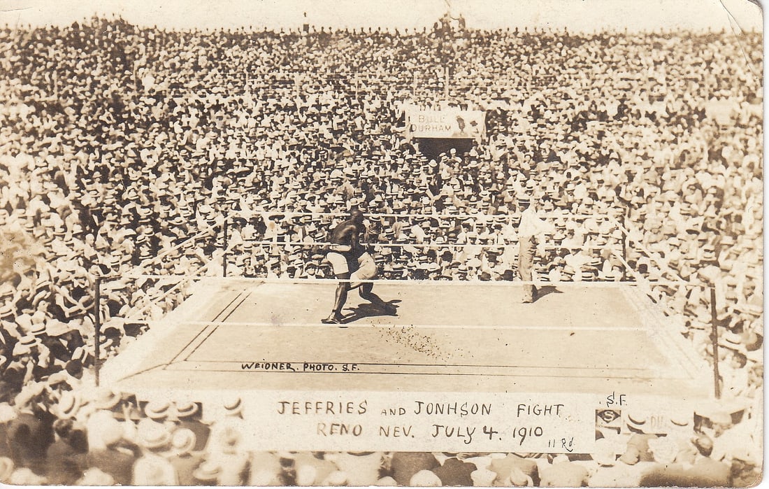 Original Photo Postcard of the 'Jim Jeffries' and 'Jack Johnson' Fight Reno Nev(ada) July 4, 1910: 'Weidner. Photo. SF.' Size 13.7x8.7cms Condition Rounded corners & writing on back Medium Memorabilia Exhibited Sports, Boxing