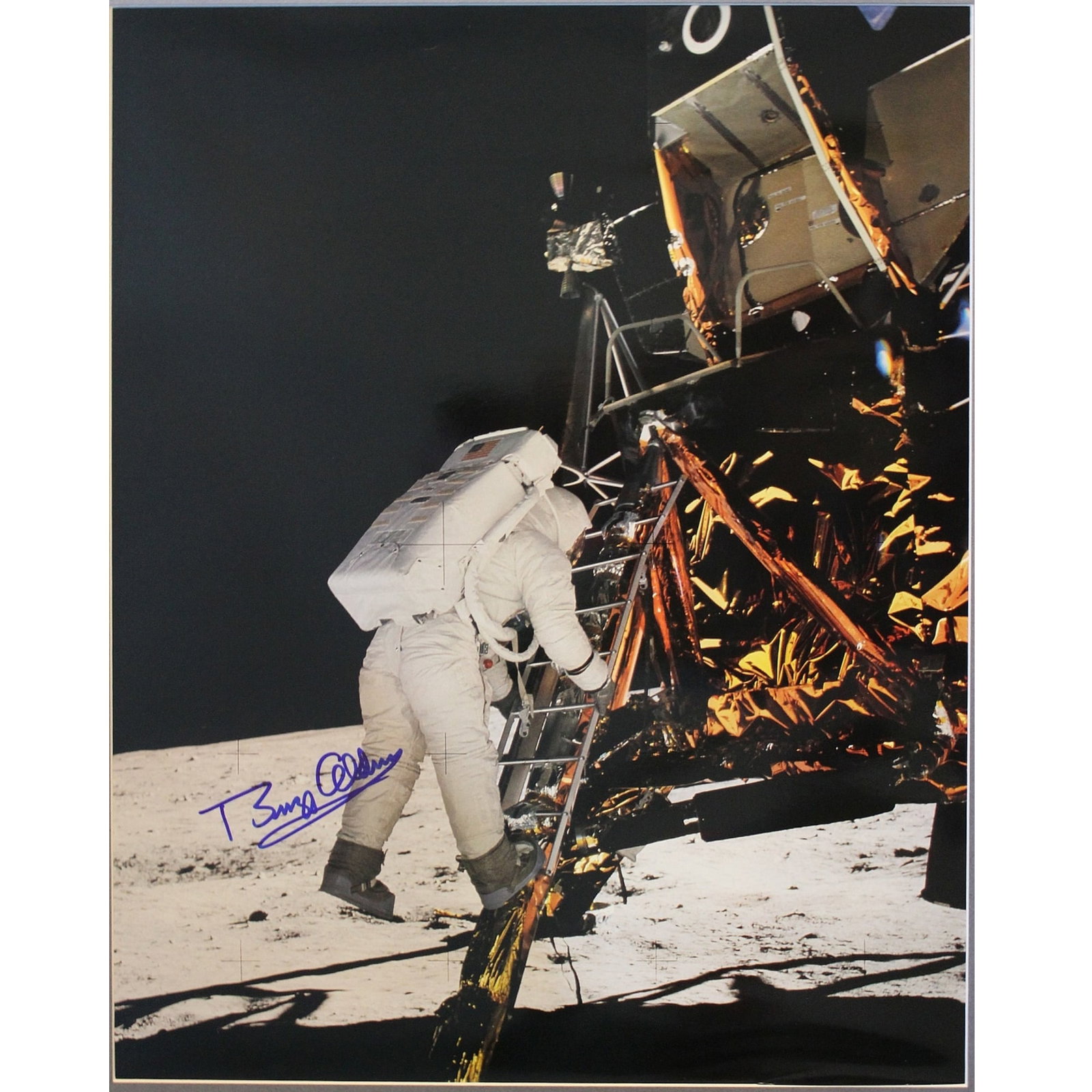 Buzz Aldrin signed photograph, “Descending the Lunar Module Eagle” prior to stepping ont: This image is a large format copy of a photograph from Aldrin's personal collection Size Frame measures 69x58.5cms Medium Autographs Provenance Produced by Nasa/Aerographics Exhibited Space Astronaut