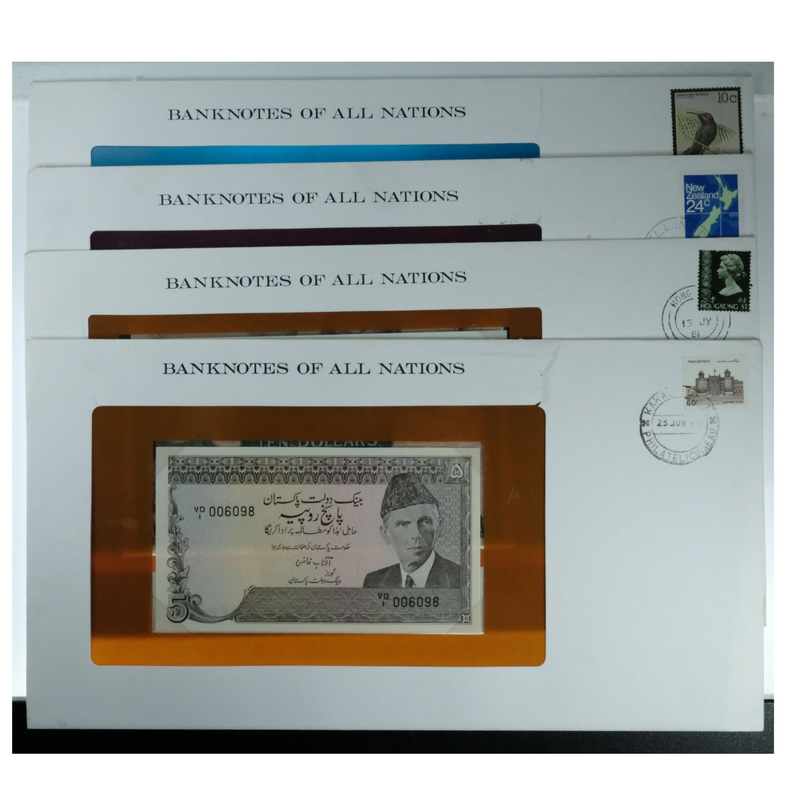 Banknotes of All Nations in Stamp Covers - Uncirculated (4 notes): Hong Kong $10, Jamaica $1, New Zealand $2, Pakistan 5 Rupees Condition Tears to envelopes