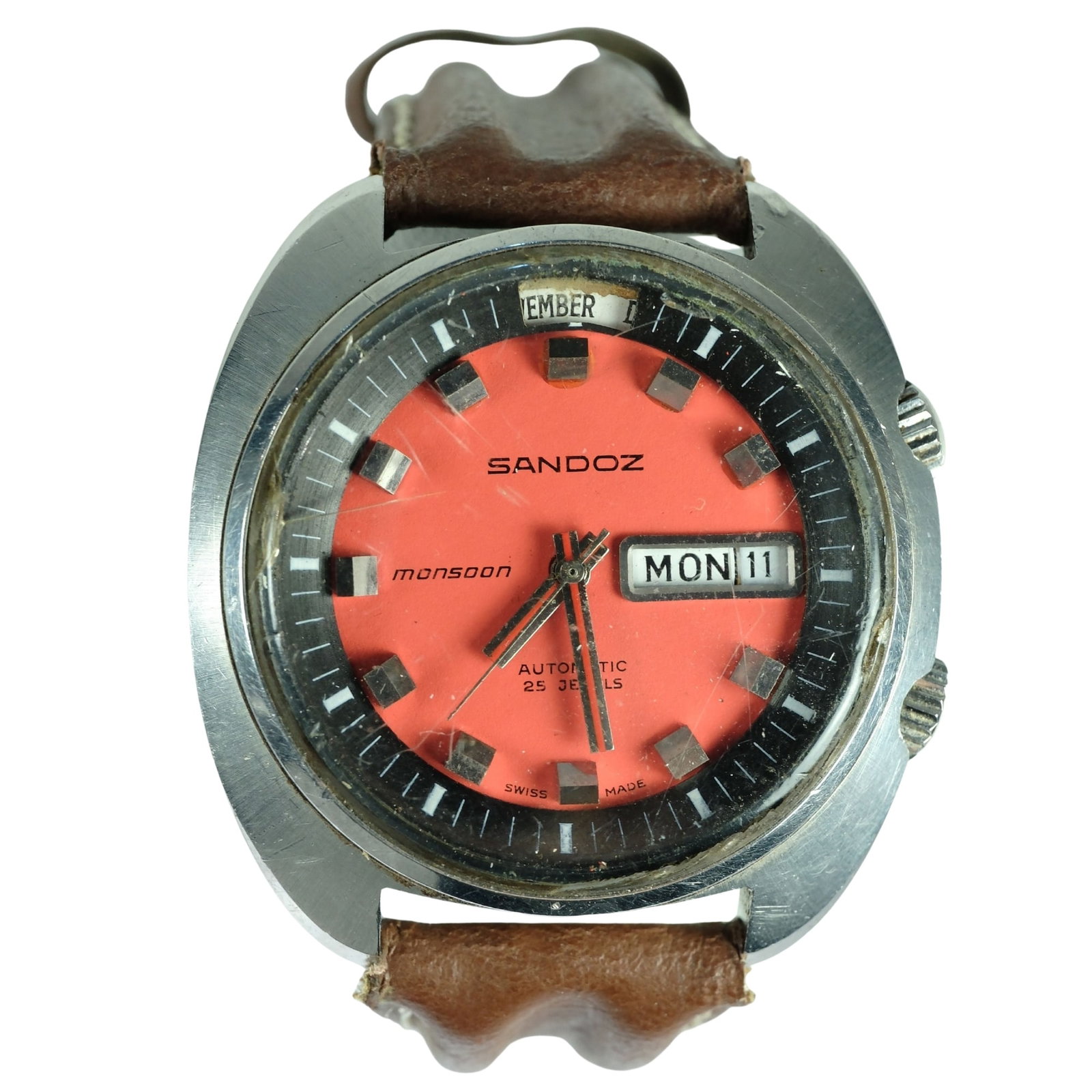 Vintage Men's Sandoz 'Monsoon Sports' Wristwatch with Silver Case & Orange Dial: Month, Day & Date Function. 25 Jewels. New Stitched leather Band Size Case approx 40mm Condition Automatic. Working, Original glass scuffed and chipped on edges Medium Vintage