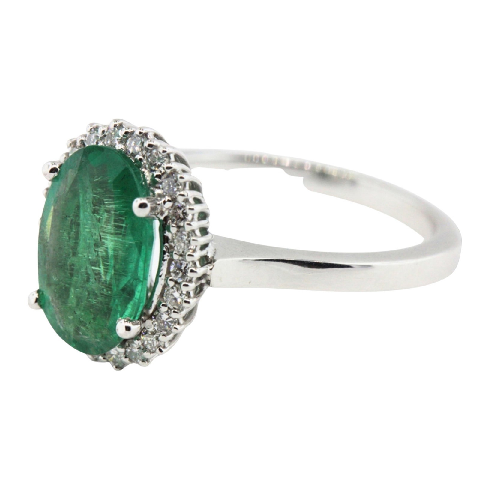 Oval-shaped Emerald & Diamond Ring in 18ct White Gold: Light coloured Emerald surrounded by a halo of 22 Brilliant Cut diamonds Size Size N : Total weight 5.03gms Medium Rings
