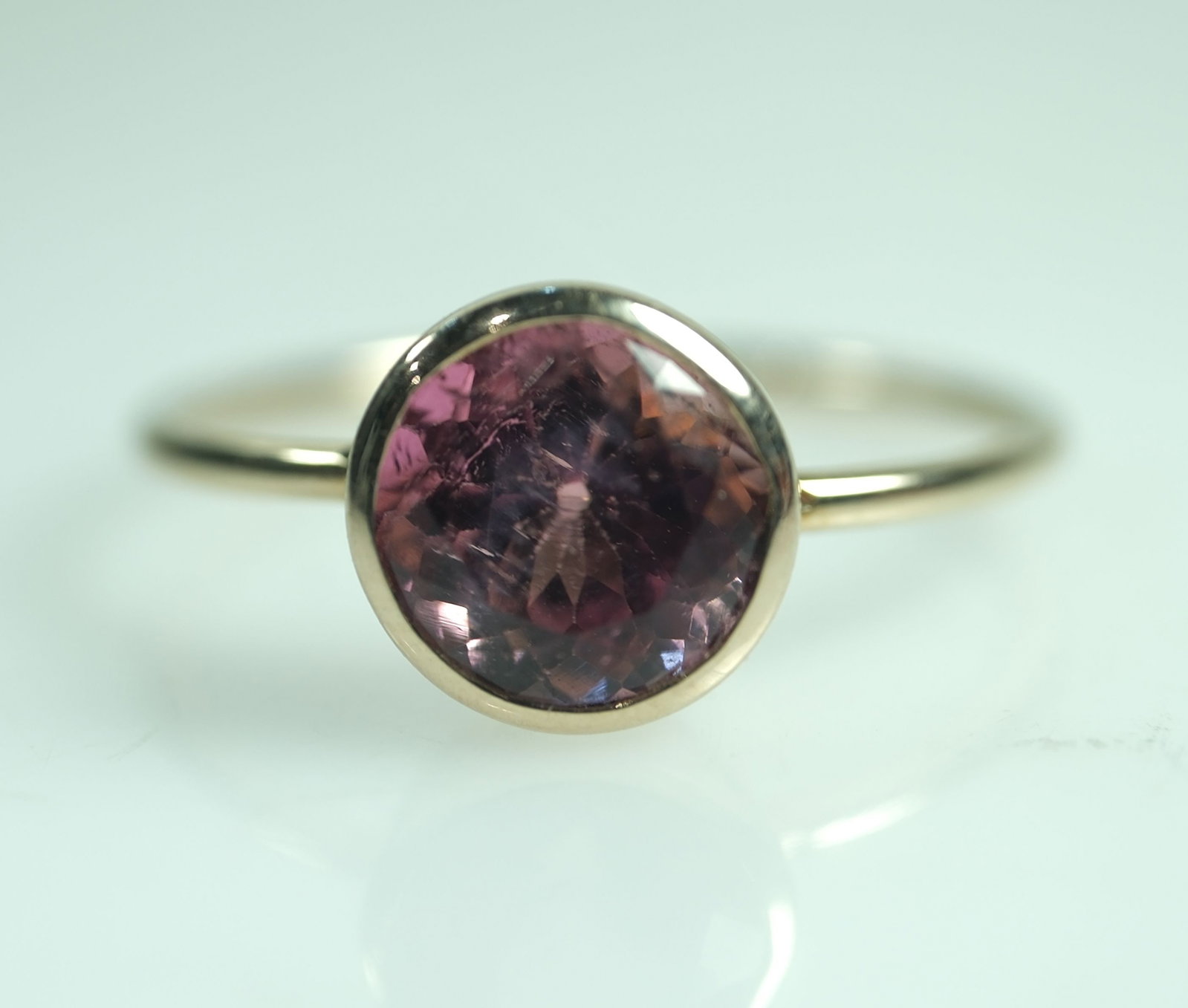 Tourmaline set in a 9ct Yellow Gold Ring: Circular form Tourmaline stone Size Size L: Total weight 1.47 gms Medium Jewelry